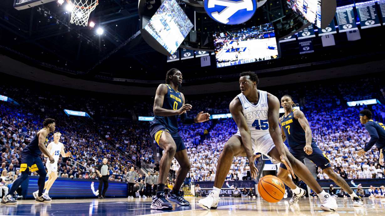 BYU center Fousseyni Traore (45) goes to the basket while guarded by West Virginia Mountaineers center Eduardo Andre (0) during an NCAA men’s basketball game held at the Marriott Center in Provo on Saturday, March 1, 2025.