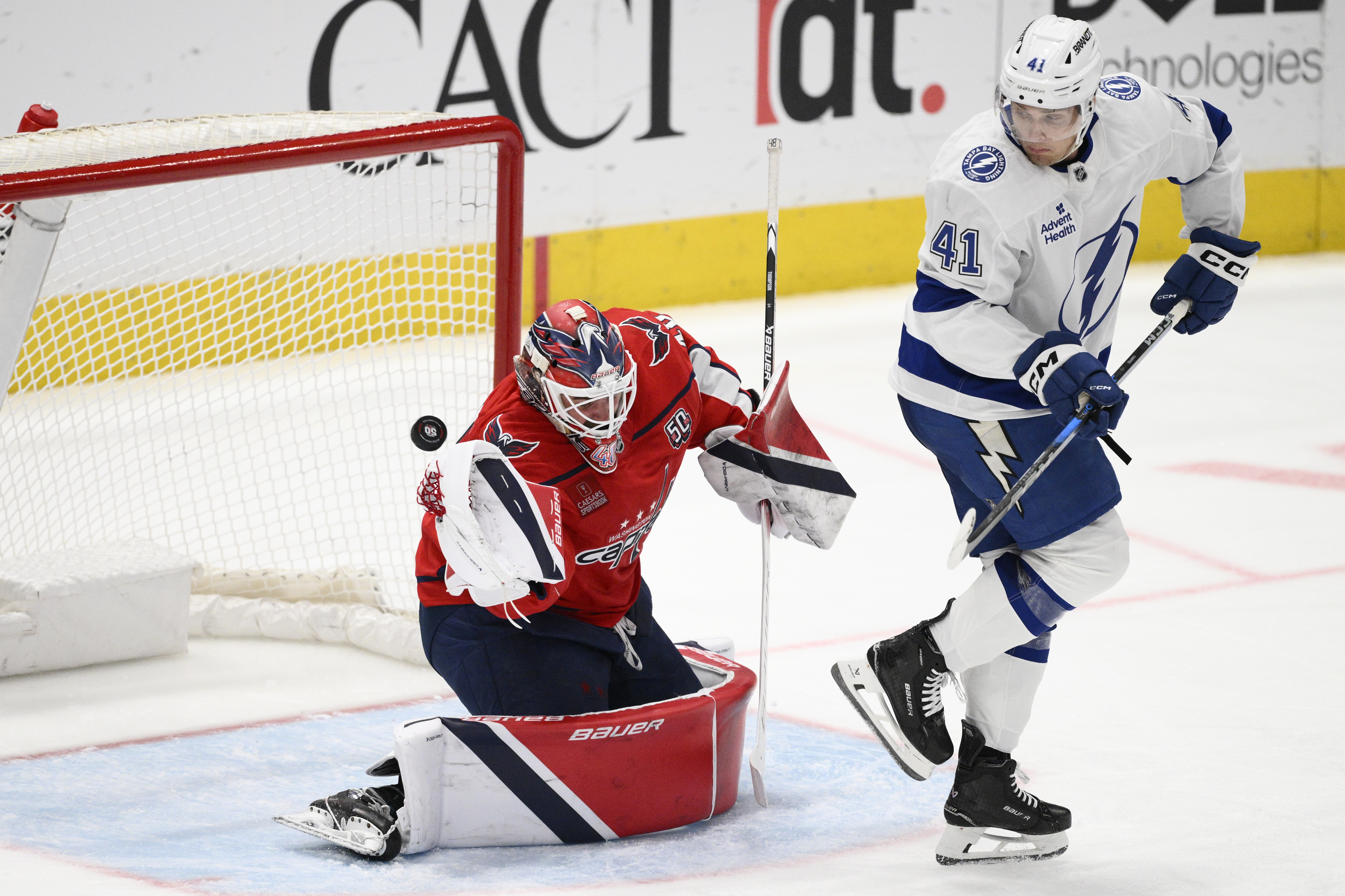 Washington Capitals goaltender Logan Thompson, left, and Tampa Bay Lightning right wing Mitchell Chaffee (41) watch the puck shot by center Gage Goncalves (93) get by for a goal during the third period of an NHL hockey game, Saturday, March 1, 2025, in Washington. 