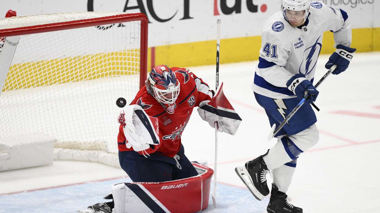 Washington Capitals goaltender Logan Thompson, left, and Tampa Bay Lightning right wing Mitchell Chaffee (41) watch the puck shot by center Gage Goncalves (93) get by for a goal during the third period of an NHL hockey game, Saturday, March 1, 2025, in Washington.