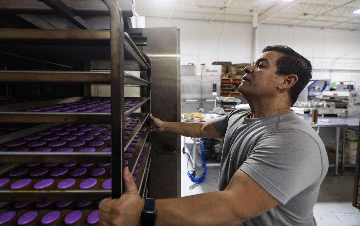 Chef Adalberto Diaz Labrada puts a batch of macarons into an oven in the kitchen of Fillings & Emulsions in Salt Lake City on Wednesday, Feb. 19.