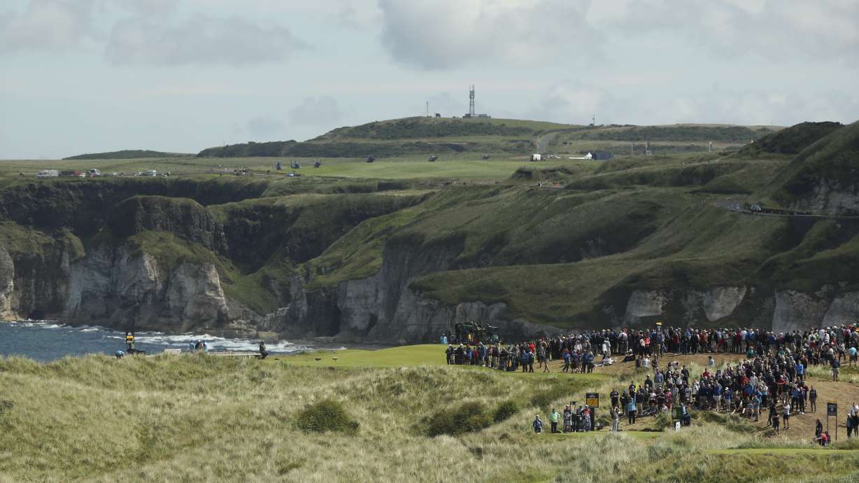 FILE - Golfers play from the 7th hole during the third round of the British Open Golf Championships at Royal Portrush in Northern Ireland, Saturday, July 20, 2019.