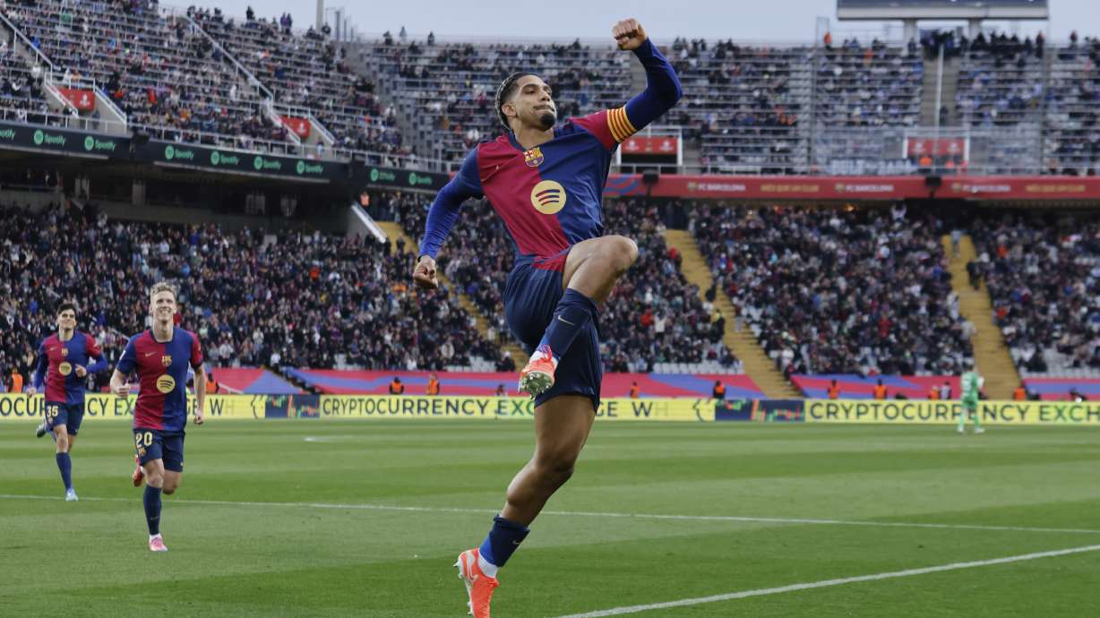 Barcelona's Ronald Araujo celebrates scoring his side's 3rd goal during the Spanish La Liga soccer match between Barcelona and Real Sociedad at the Lluis Companys Olympic Stadium in Barcelona, Spain, Sunday, March 2, 2025.