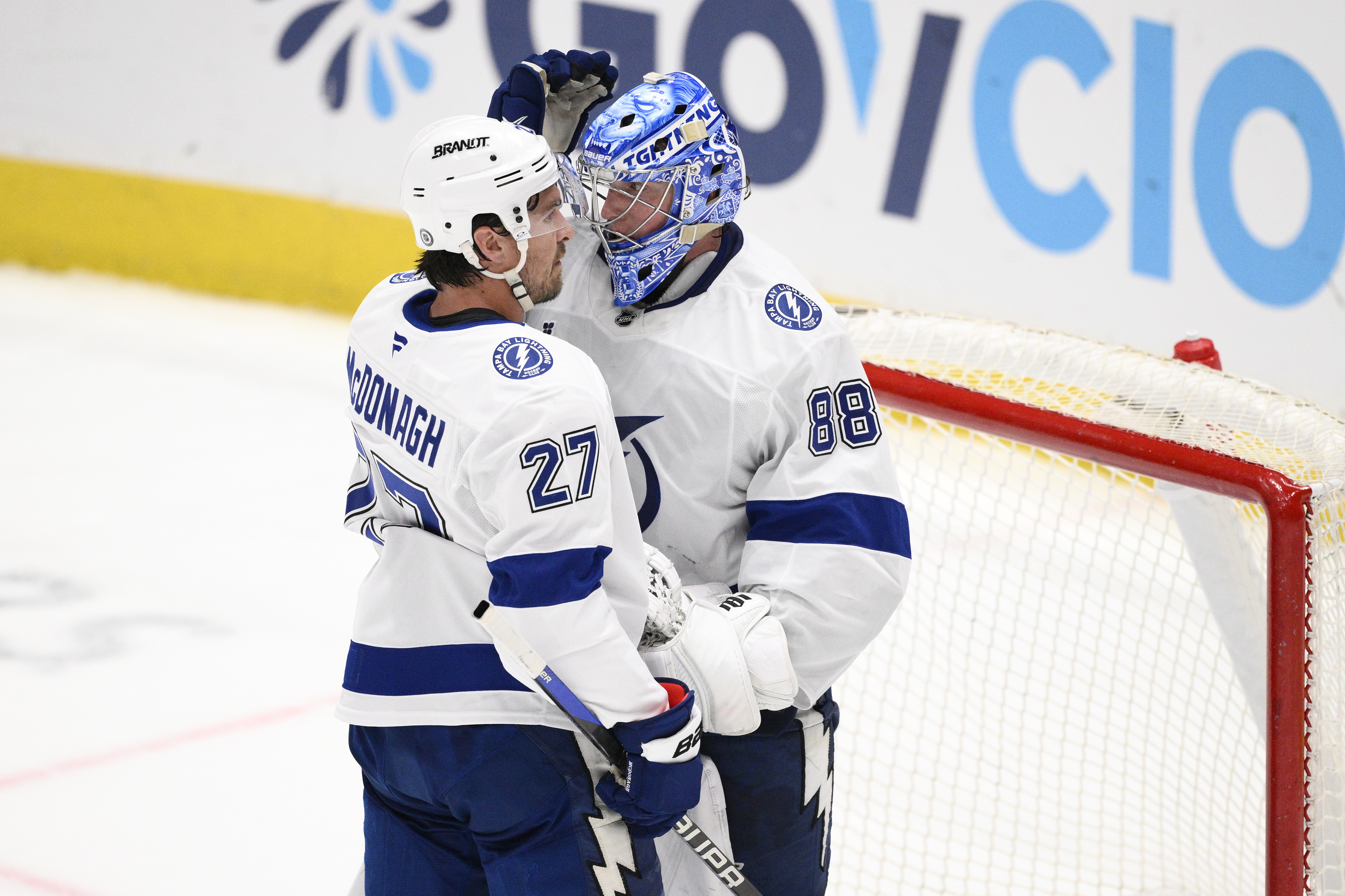 Tampa Bay Lightning defenseman Ryan McDonagh (27) and goaltender Andrei Vasilevskiy (88) celebrate after an NHL hockey game against the Washington Capitals, Saturday, March 1, 2025, in Washington.