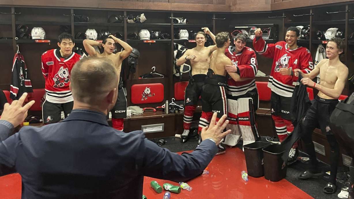 Members of the Niagara Ice Dogs mob goalie Hayden Jeffery in St. Catharines, Canada, March 1, 2025.