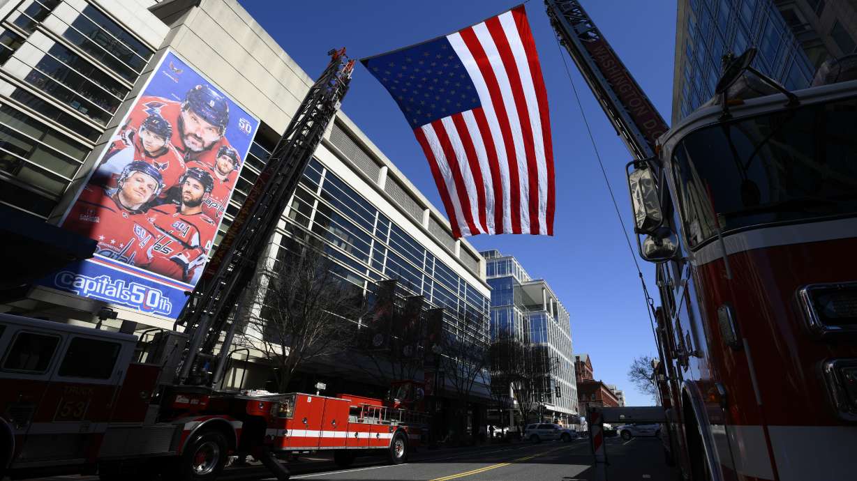 An American flag is flown outside of Capital One Arena before the Legacy on Ice event, a figure skating tribute to support the families and loved ones affected by the tragic January 29th aviation incident, Sunday, March 2, 2025, in Washington.