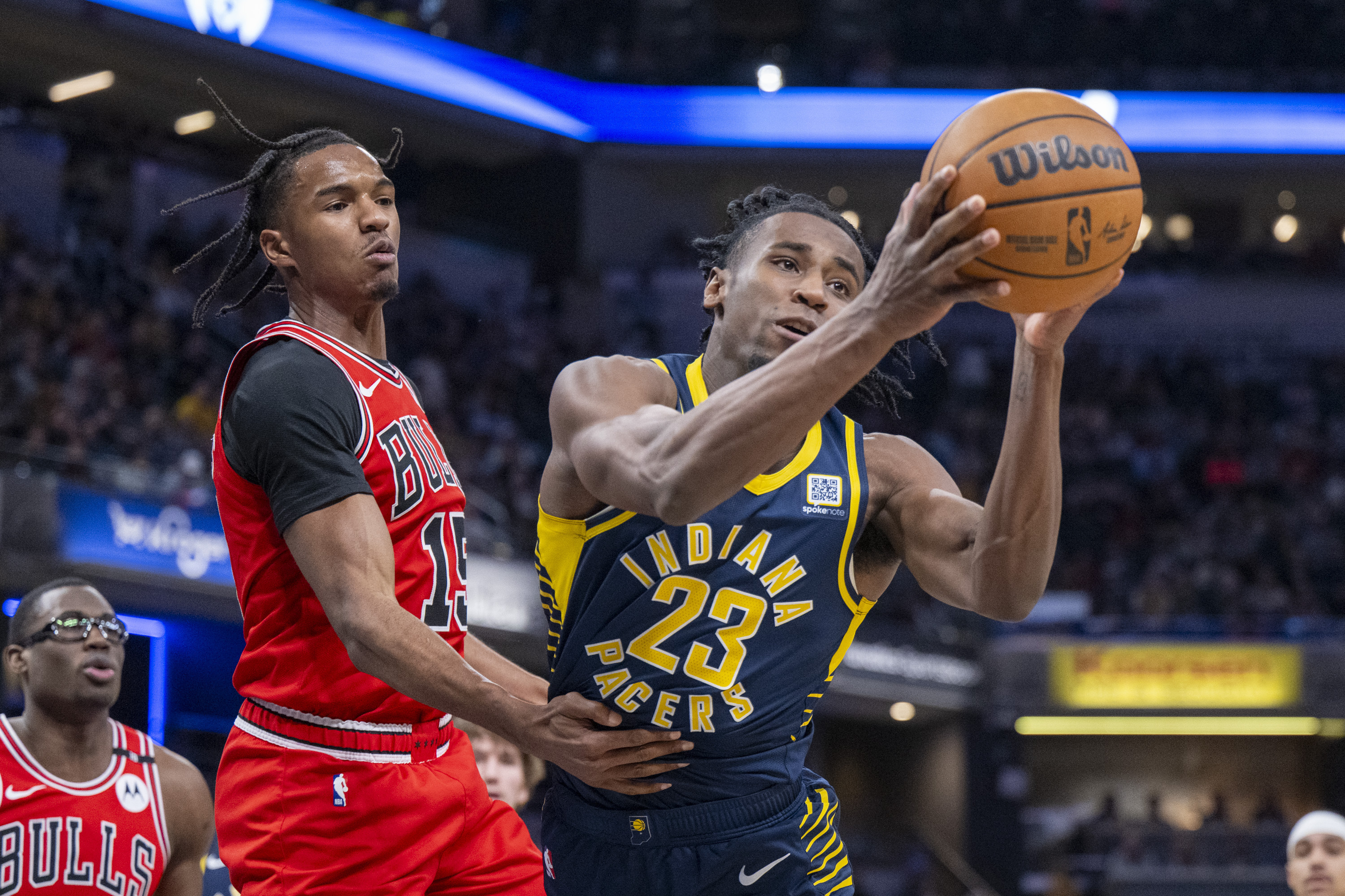 Indiana Pacers forward Aaron Nesmith (23) reaches for a rebound against Chicago Bulls forward Julian Phillips during the first half of an NBA basketball game in Indianapolis, Sunday, March 2, 2025. 
