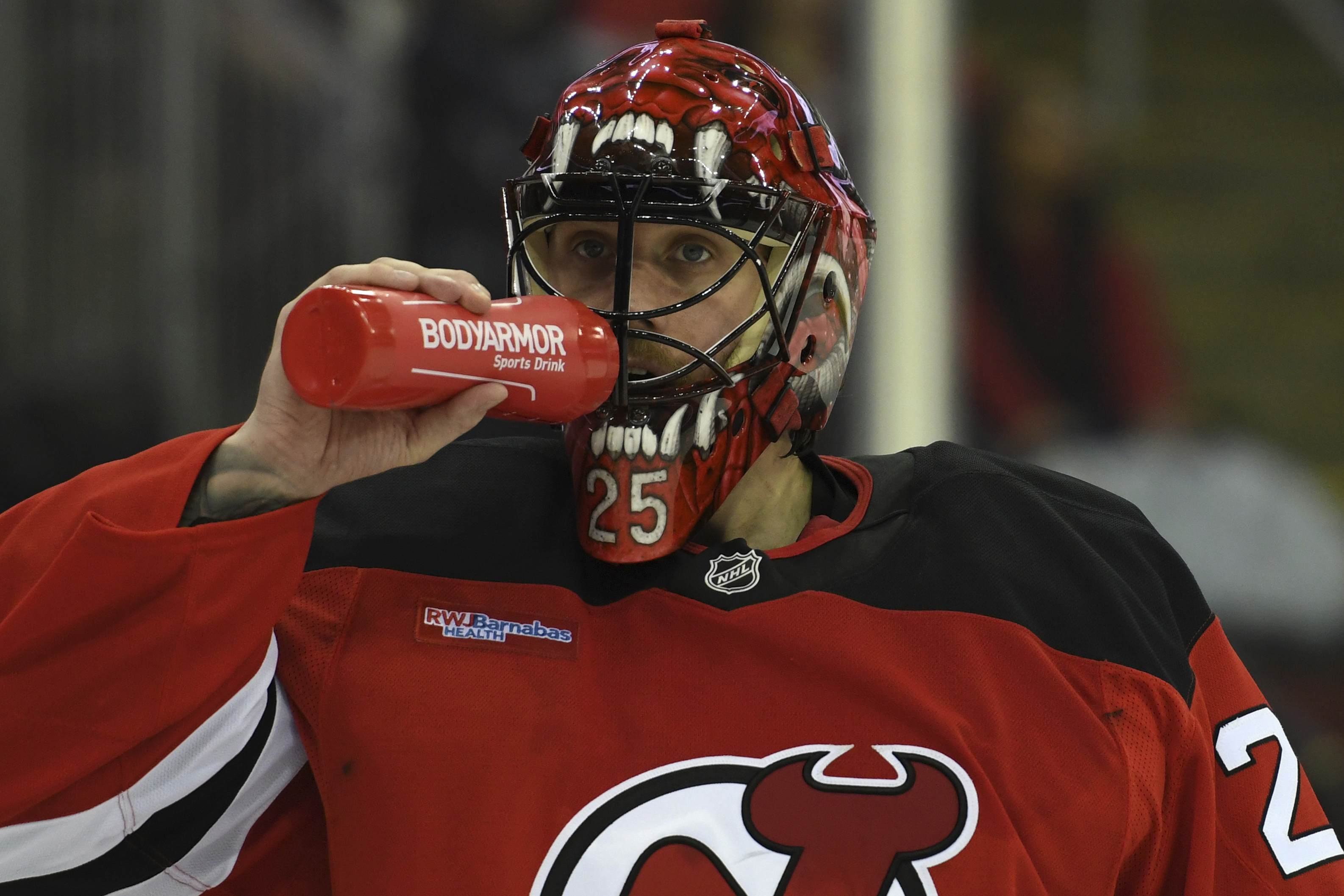 FILE - New Jersey Devils' Jacob Markstrom drinks water during the third period of an NHL hockey game against the Ottawa Senators, on Jan. 19, 2025, in Newark, N.J. 