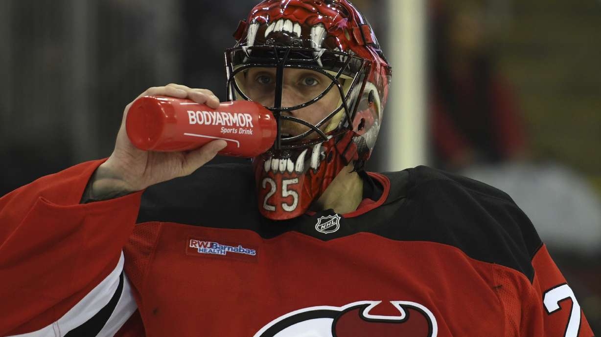 FILE - New Jersey Devils' Jacob Markstrom drinks water during the third period of an NHL hockey game against the Ottawa Senators, on Jan. 19, 2025, in Newark, N.J.