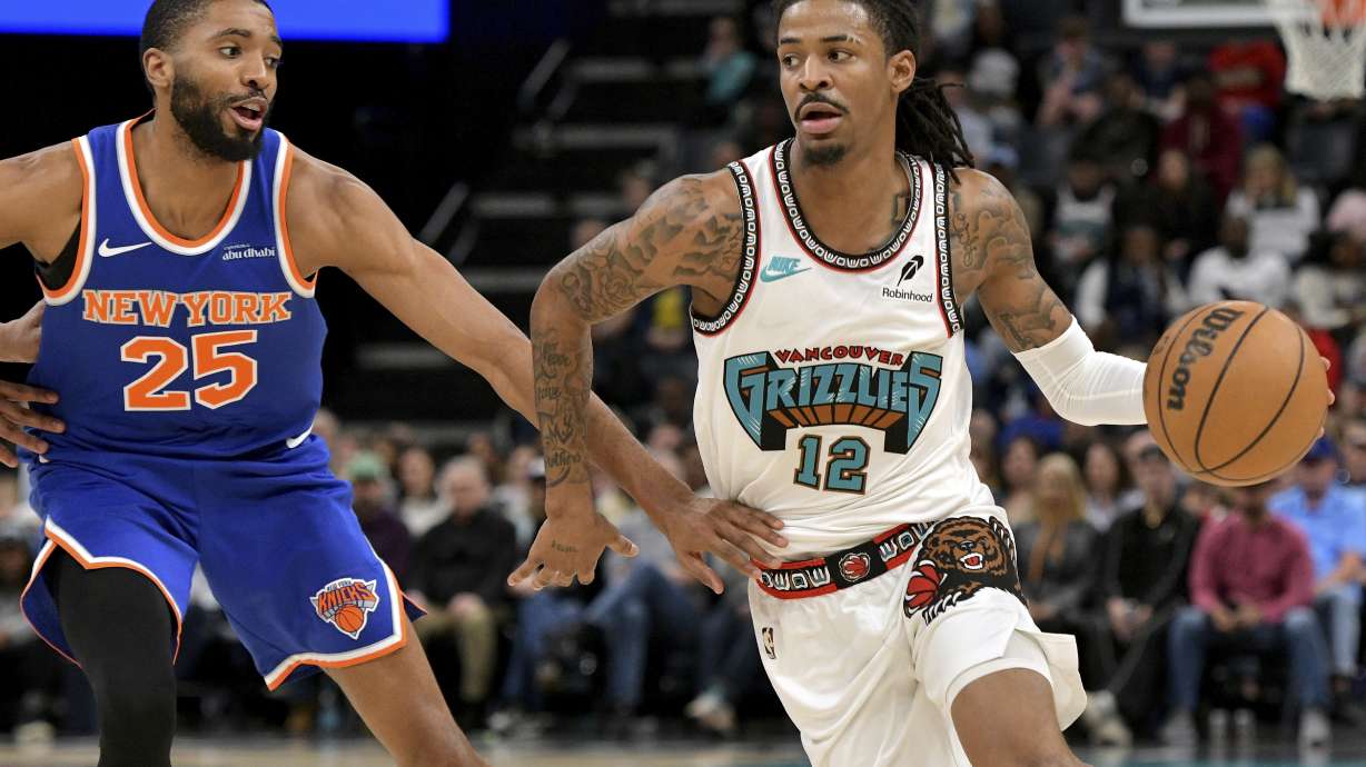 Memphis Grizzlies guard Ja Morant (12) handles the ball against New York Knicks forward Mikal Bridges (25) in the second half of an NBA basketball game Friday, Feb. 28, 2025, in Memphis, Tenn.