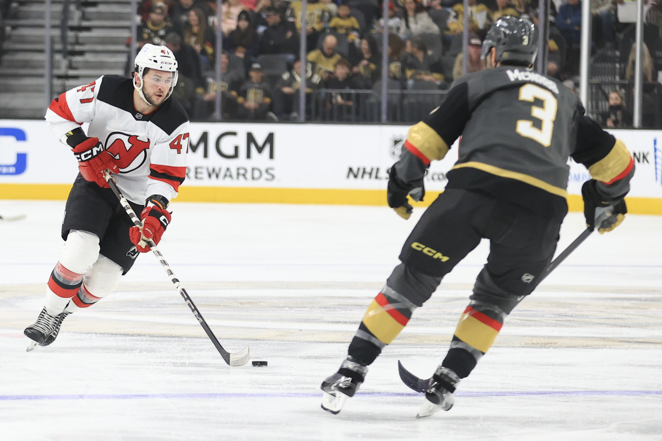 New Jersey Devils center Paul Cotter (47) skates against Vegas Golden Knights defenseman Brayden McNabb (3) during the first period of an NHL hockey game Sunday, March 2, 2025, in Las Vegas. 