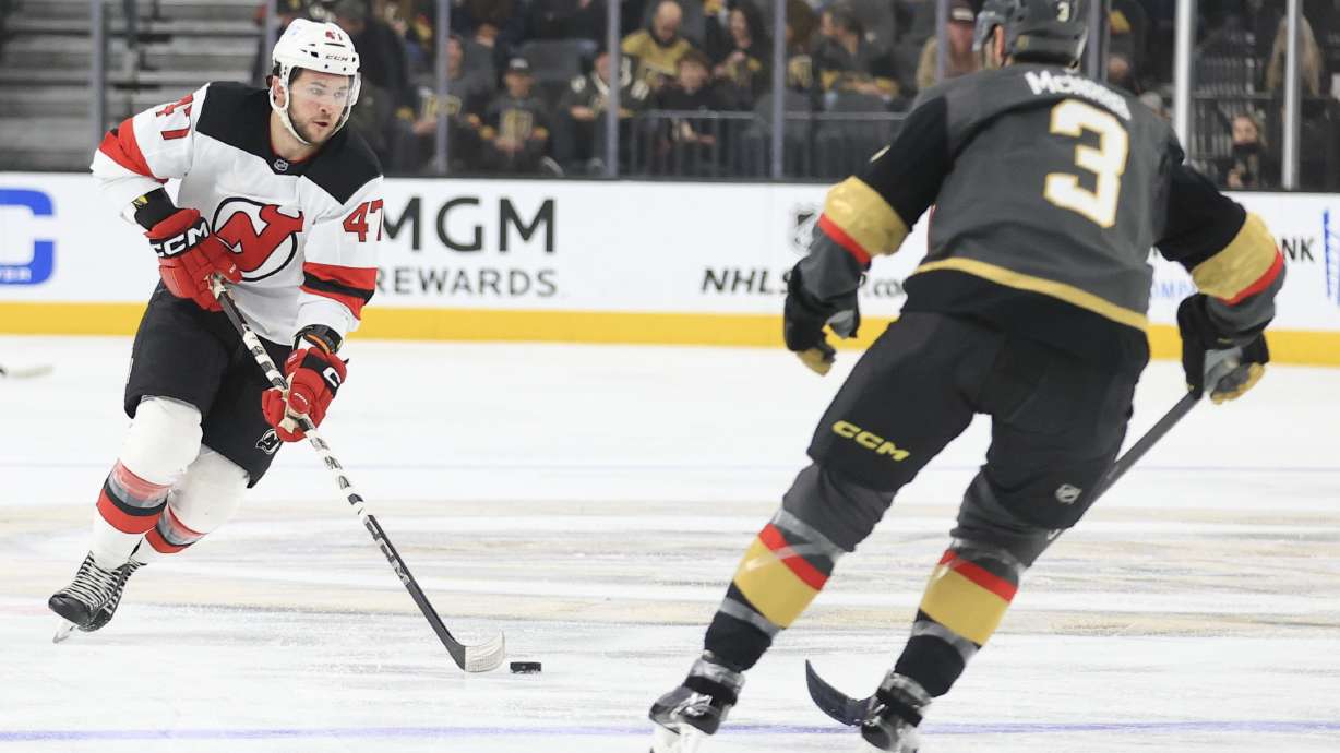New Jersey Devils center Paul Cotter (47) skates against Vegas Golden Knights defenseman Brayden McNabb (3) during the first period of an NHL hockey game Sunday, March 2, 2025, in Las Vegas.