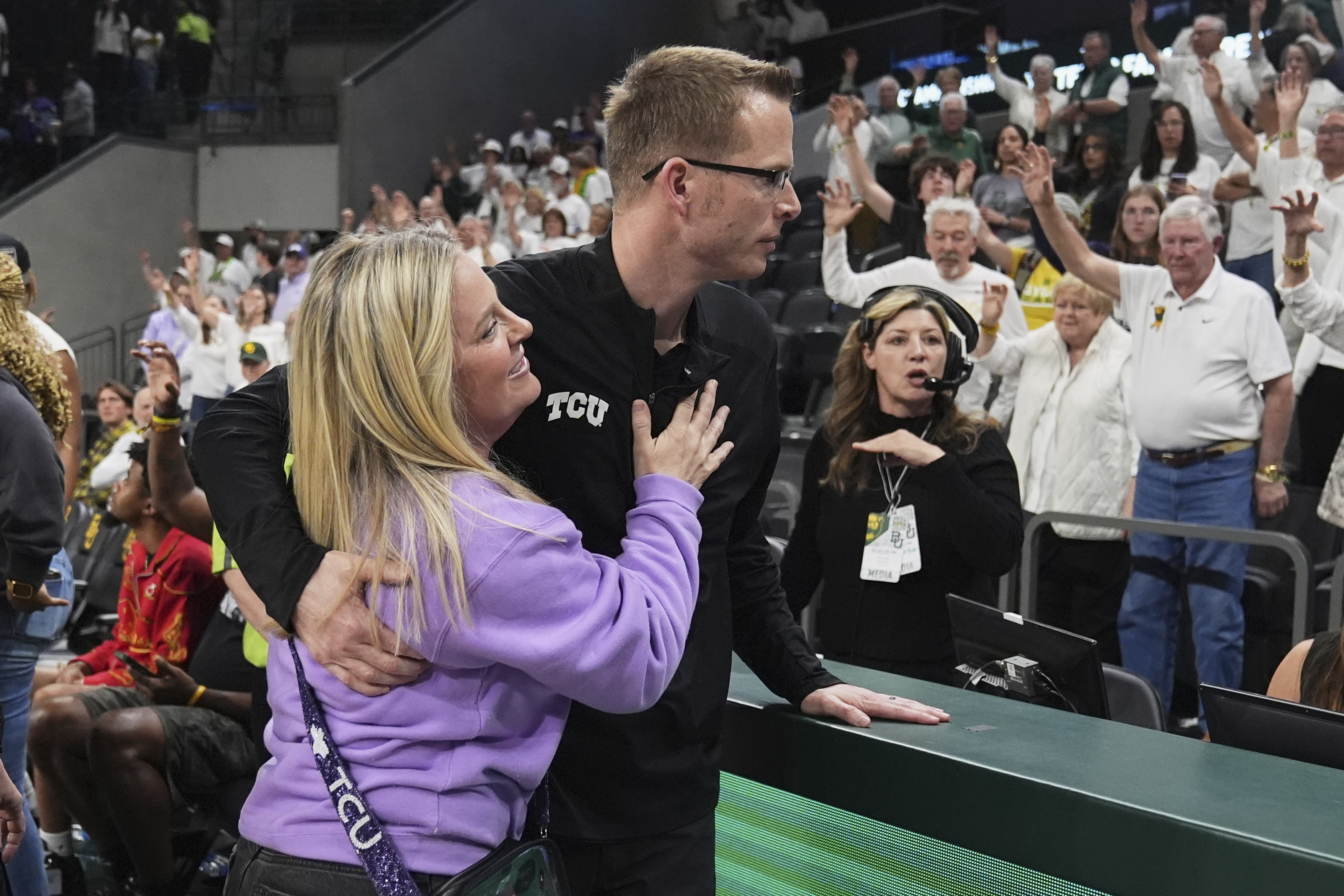 TCU head basketball coach Mark Campbell hugs his wife Ashley, left, after his team's win against Baylor in an NCAA college basketball game in Waco, Texas, Sunday, March 2, 2025.