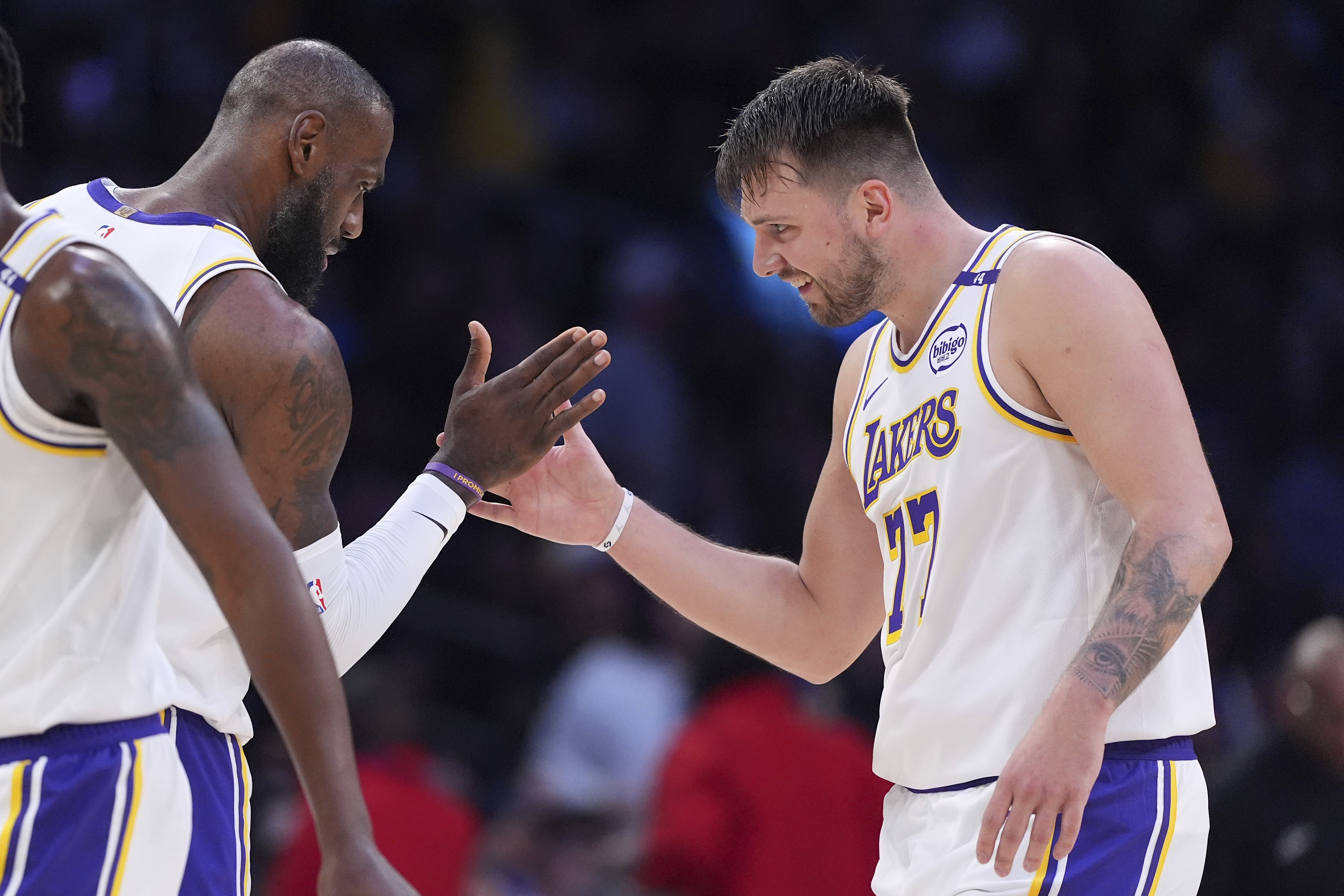 Los Angeles Lakers guard Luka Doncic, right, is congratulated by forward LeBron James after scoring during the first half of an NBA basketball game against the Los Angeles Clippers, Sunday, March 2, 2025, in Los Angeles. 