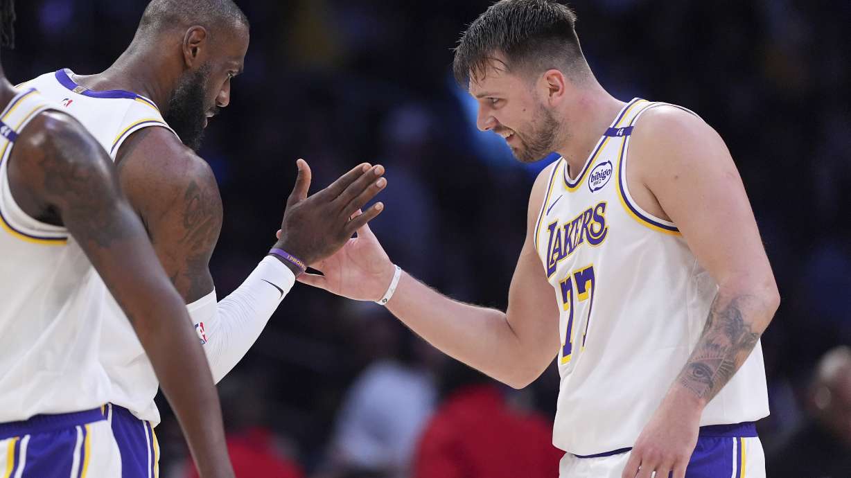 Los Angeles Lakers guard Luka Doncic, right, is congratulated by forward LeBron James after scoring during the first half of an NBA basketball game against the Los Angeles Clippers, Sunday, March 2, 2025, in Los Angeles.