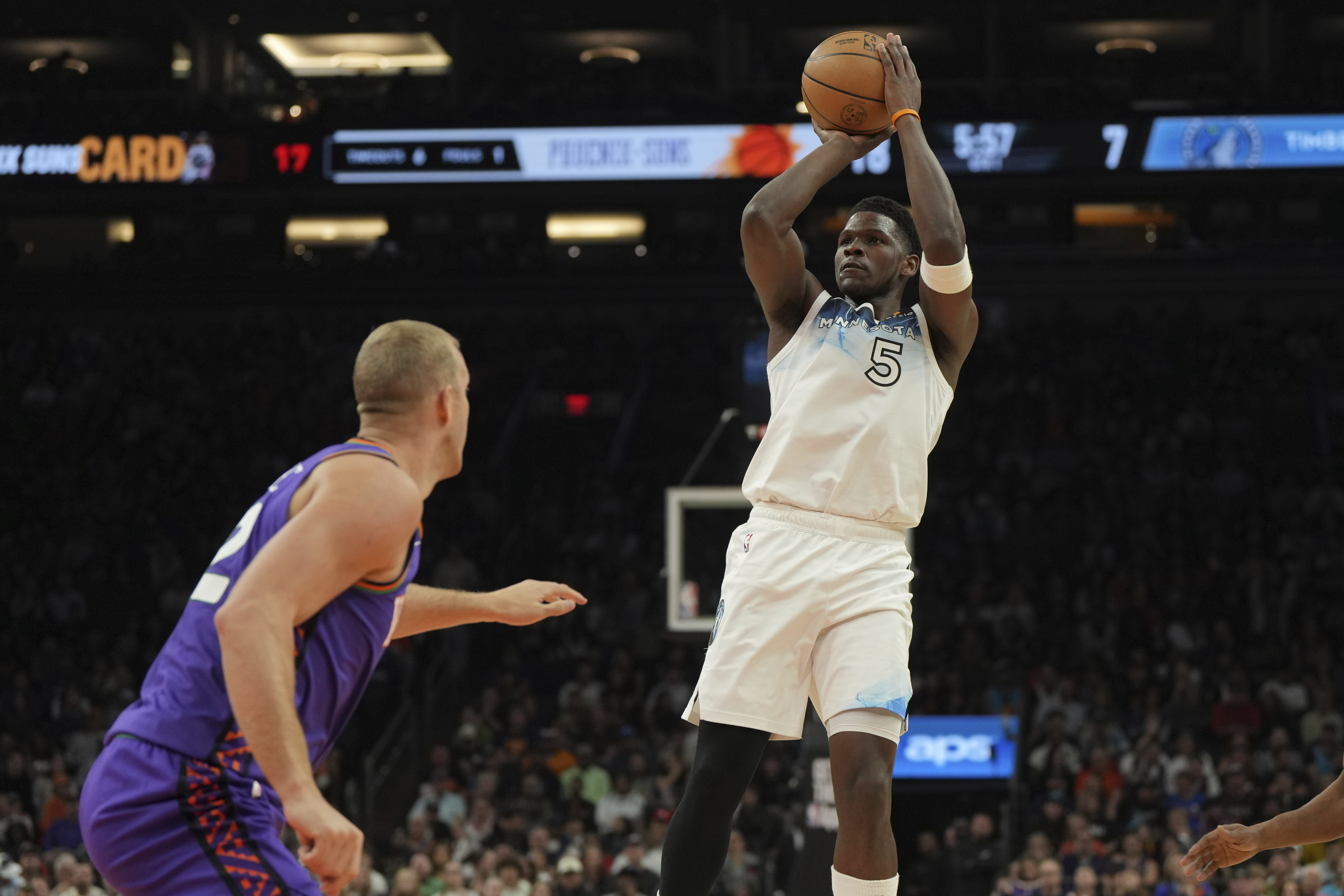 Minnesota Timberwolves guard Anthony Edwards (5) shoots over Phoenix Suns center Mason Plumlee during the first half of an NBA basketball game, Sunday, March 2, 2025, in Phoenix. 