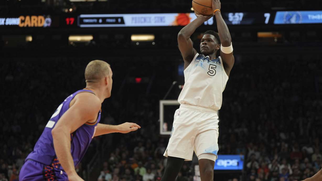 Minnesota Timberwolves guard Anthony Edwards (5) shoots over Phoenix Suns center Mason Plumlee during the first half of an NBA basketball game, Sunday, March 2, 2025, in Phoenix.