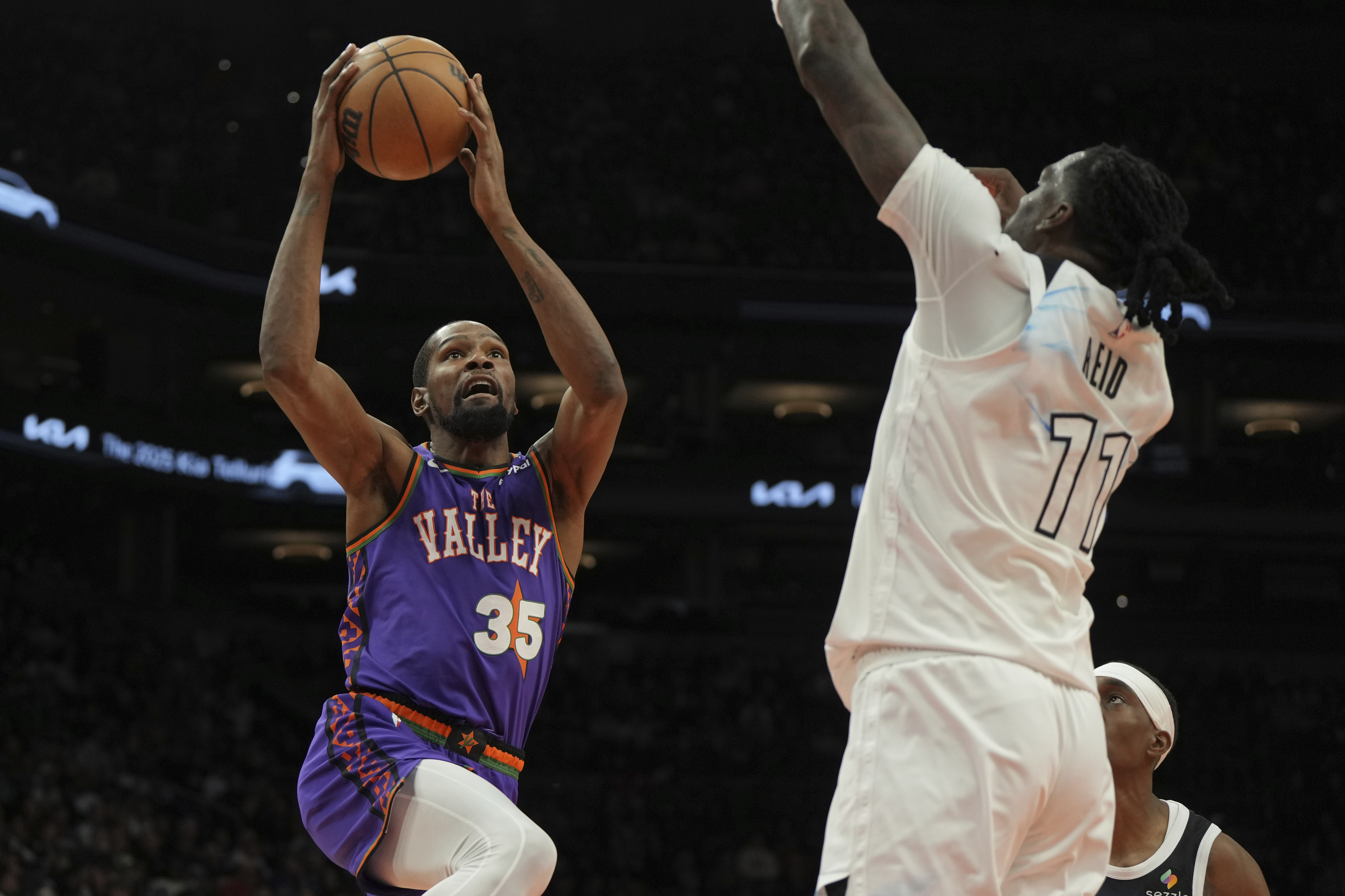 Phoenix Suns forward Kevin Durant drives on Minnesota Timberwolves center Naz Reid (11) during the second half of an NBA basketball game, Sunday, March 2, 2025, in Phoenix. 