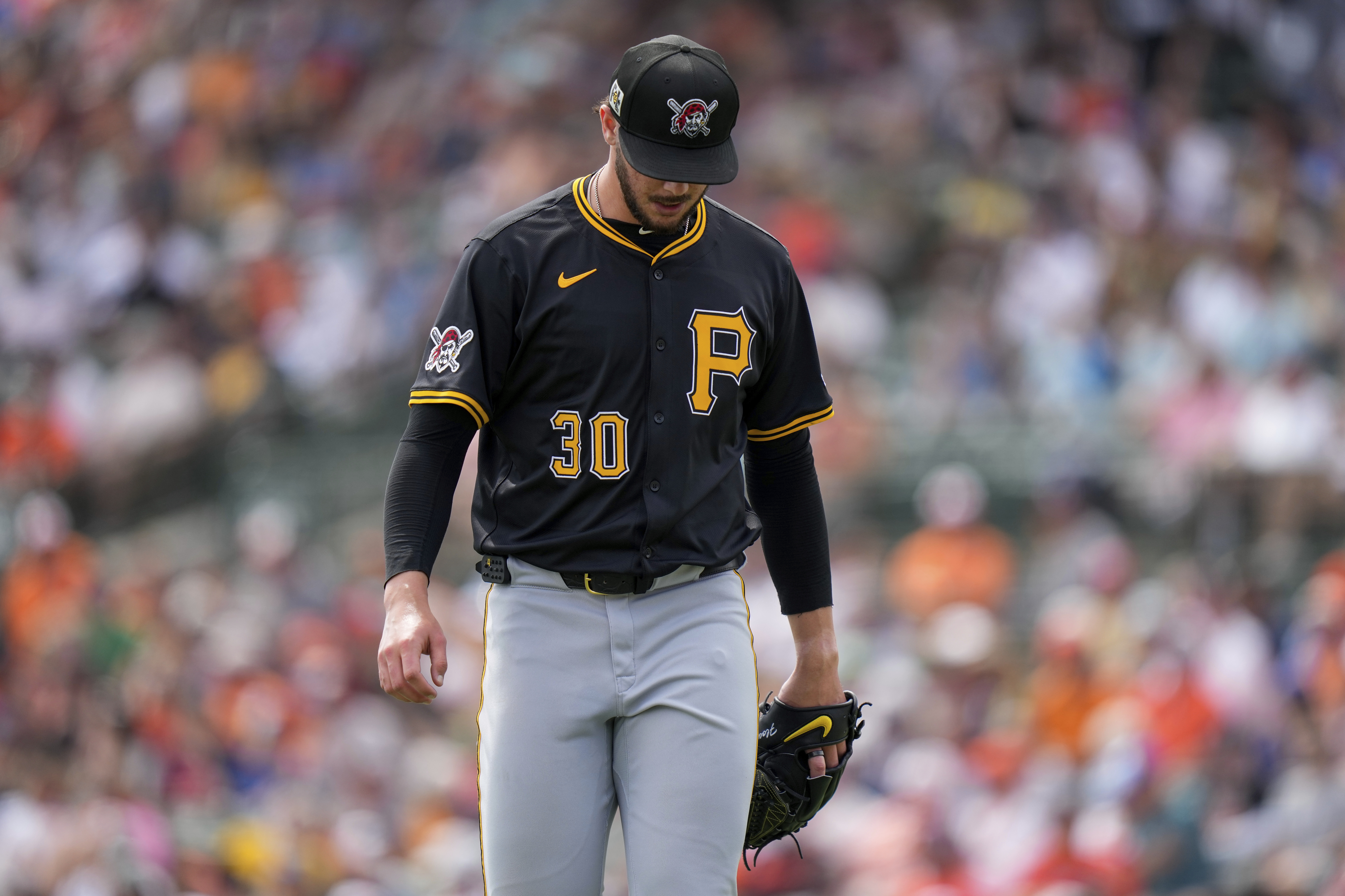 Pittsburgh Pirates starting pitcher Paul Skenes (30) returns to the dugout after the first inning of a spring training baseball game against the Baltimore Orioles, Saturday, March 1, 2025, in Sarasota, Fla.