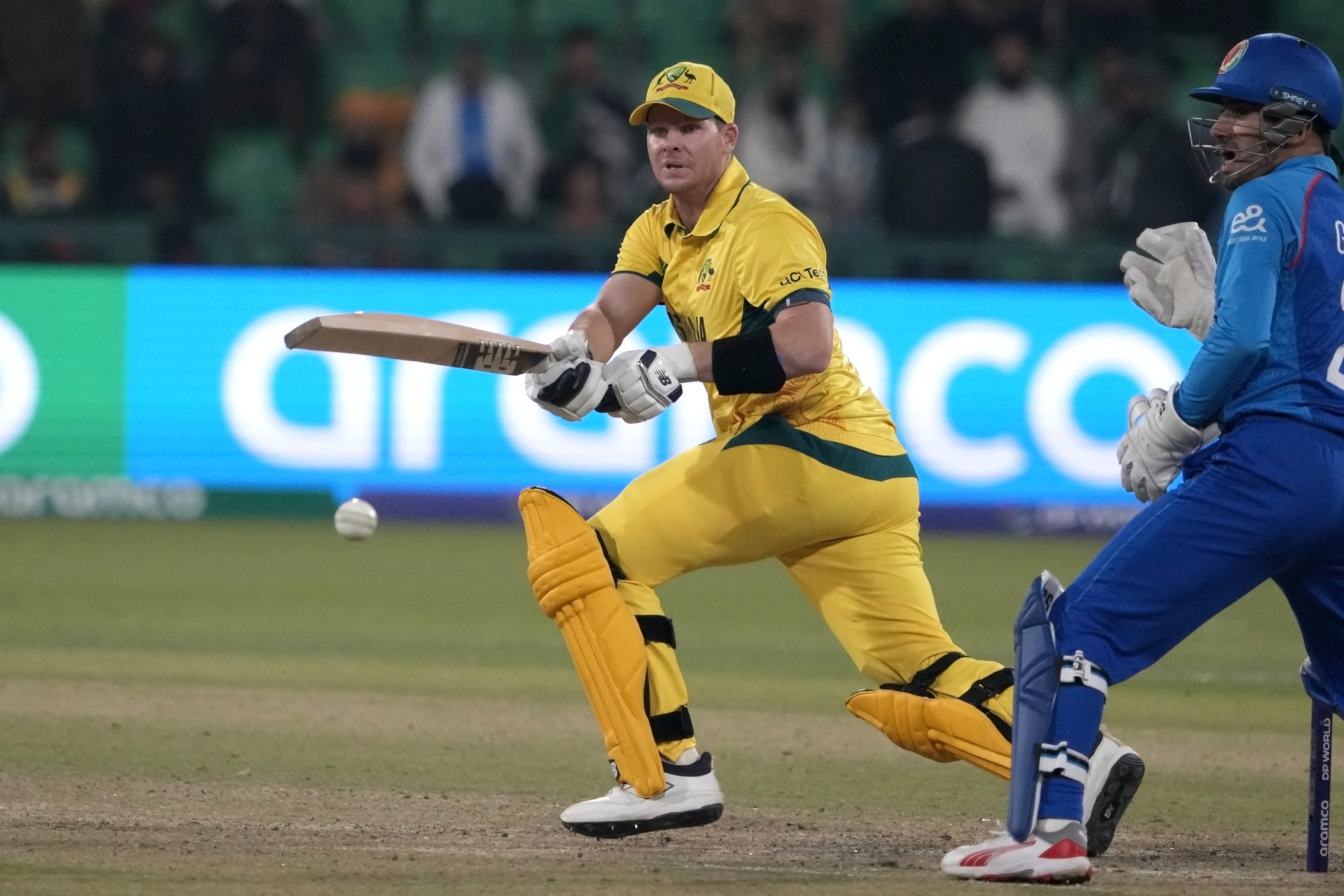 Australia's Steve Smith, center, plays a shot during the ICC Champions Trophy cricket match between Australia and Afghanistan, in Lahore, Pakistan, Friday, Feb. 28, 2025. 