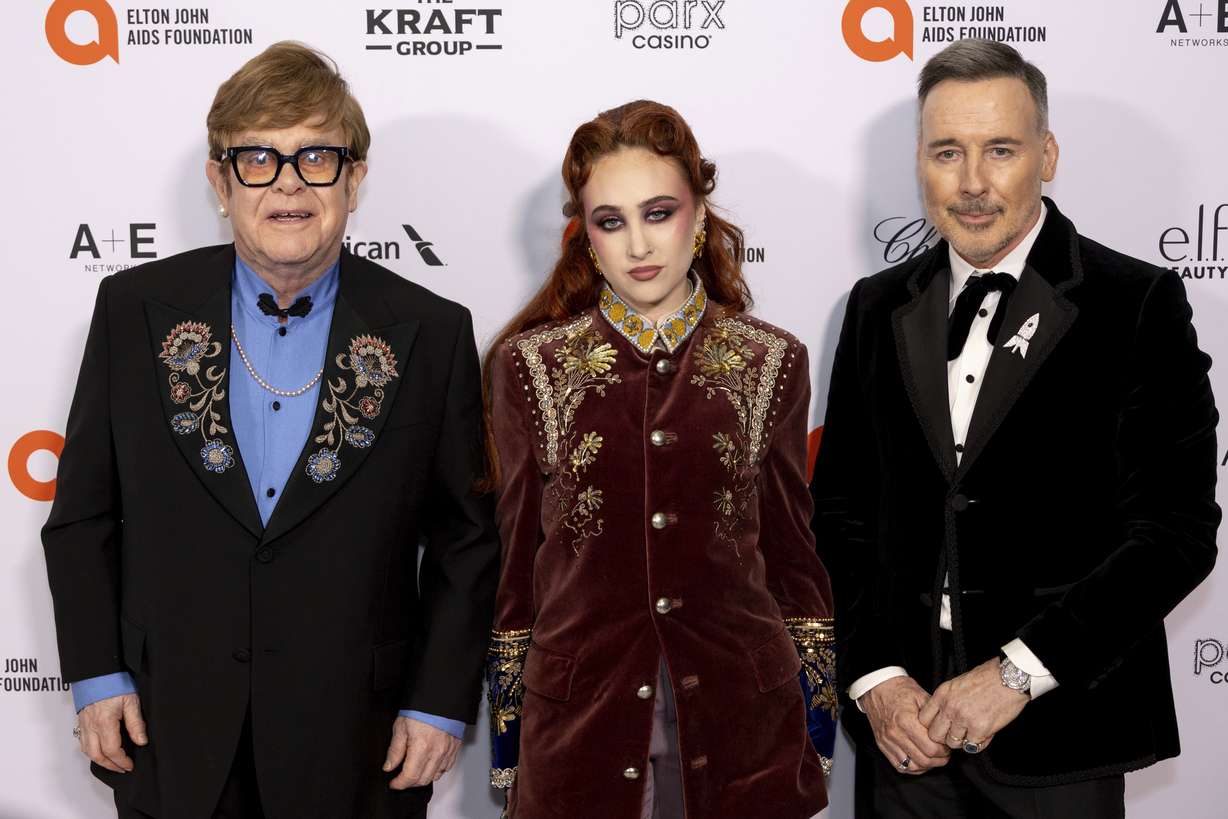 Elton John, Chapell Roan and David Furnish arrive at the 33rd Annual Elton John AIDS Foundation Academy Awards Viewing Party on Sunday, in West Hollywood, Calif.