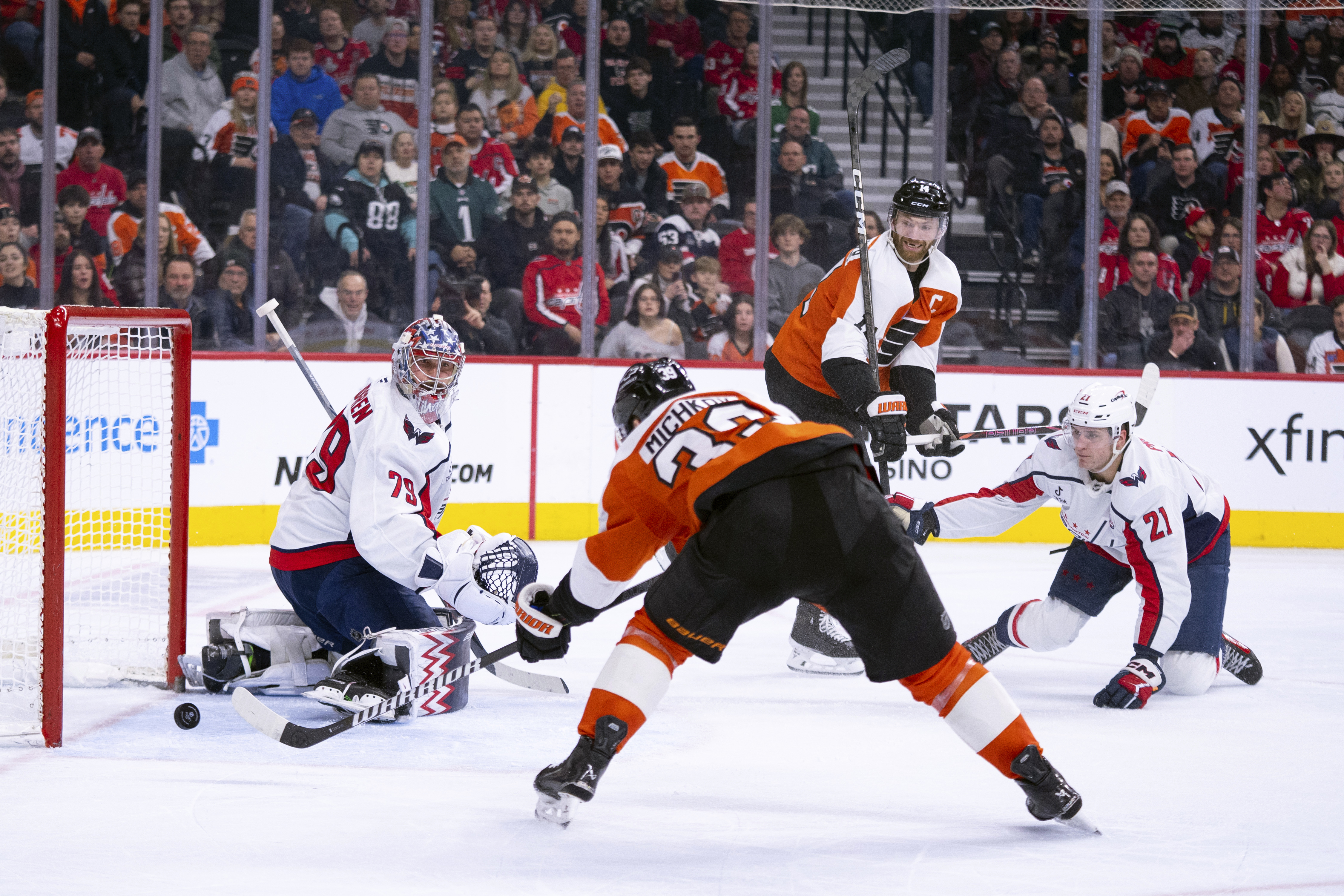 Philadelphia Flyers' Matvei Michkov, center left, shoots the puck past Washington Capitals' Charlie Lindgren, left for a goal during the second period of an NHL hockey game, Thursday, Feb. 6, 2025, in Philadelphia.