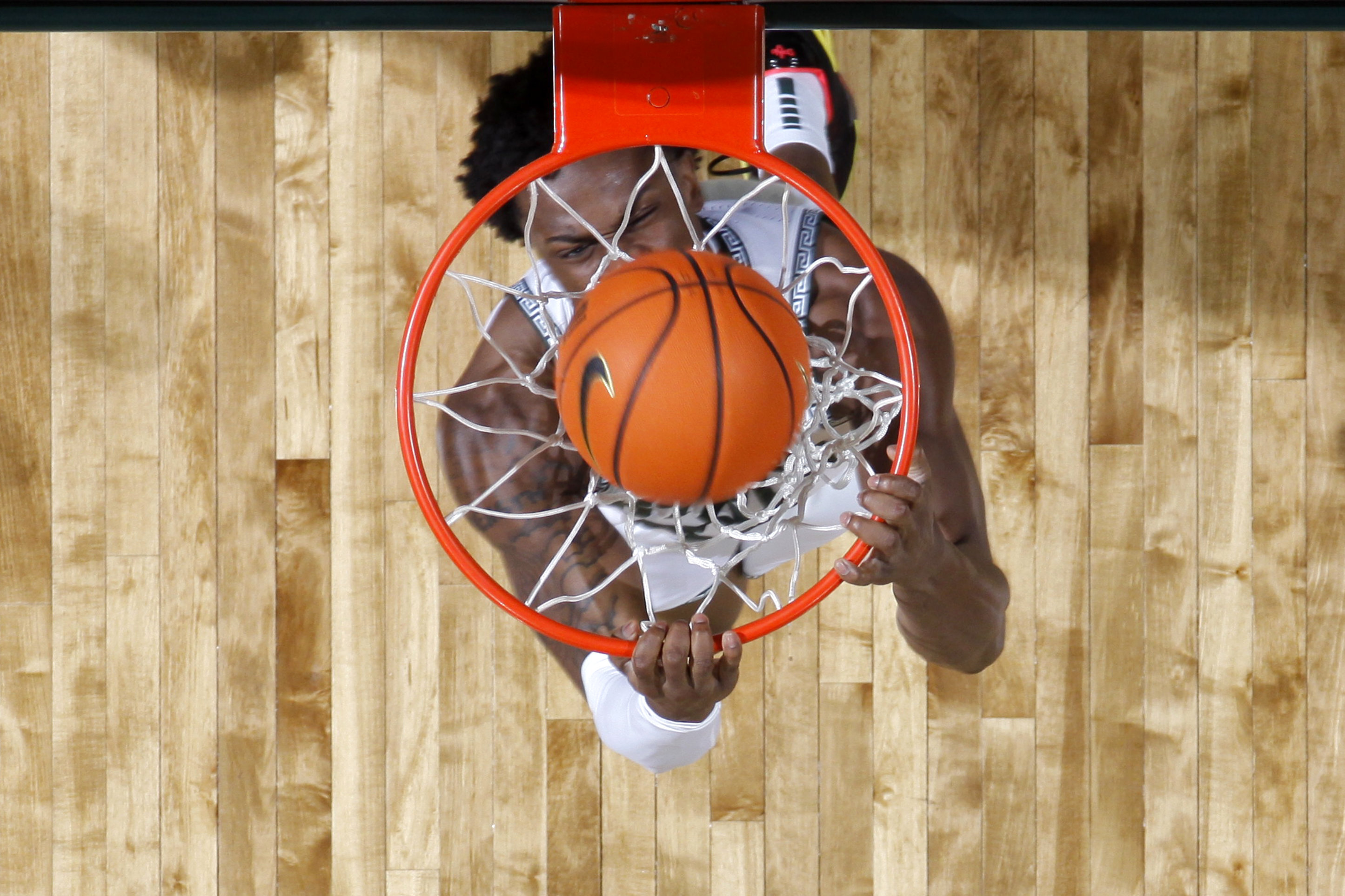 Michigan State forward Coen Carr throws down a reverse dunk during the first half of an NCAA college basketball game against Wisconsin, Sunday, March 2, 2025, in East Lansing, Mich.