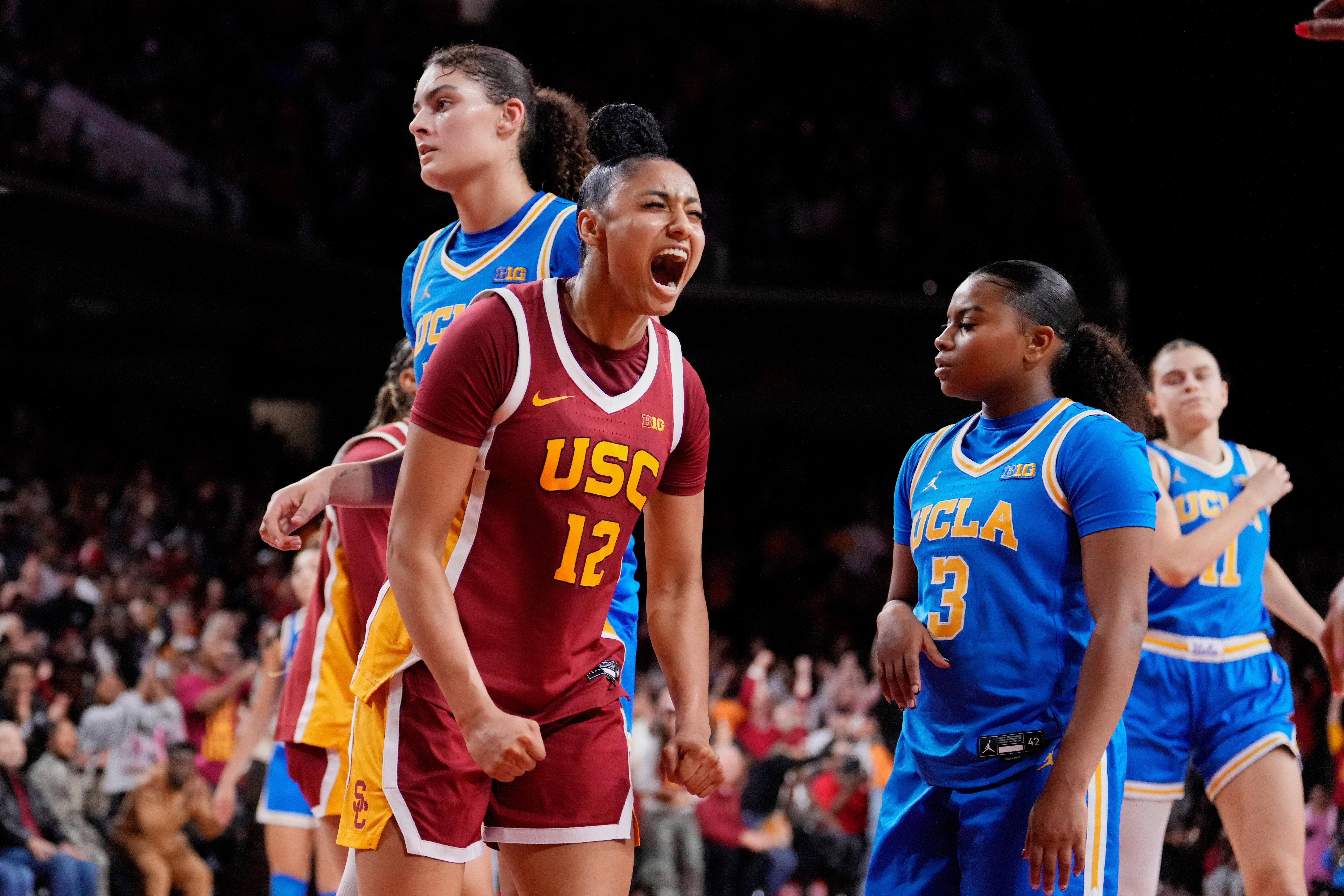FILE - Southern California guard JuJu Watkins (12) celebrates after scoring as UCLA center Lauren Betts (51) and guard Londynn Jones (3) look on during the second half of an NCAA college basketball game, Thursday, Feb. 13, 2025, in Los Angeles. 