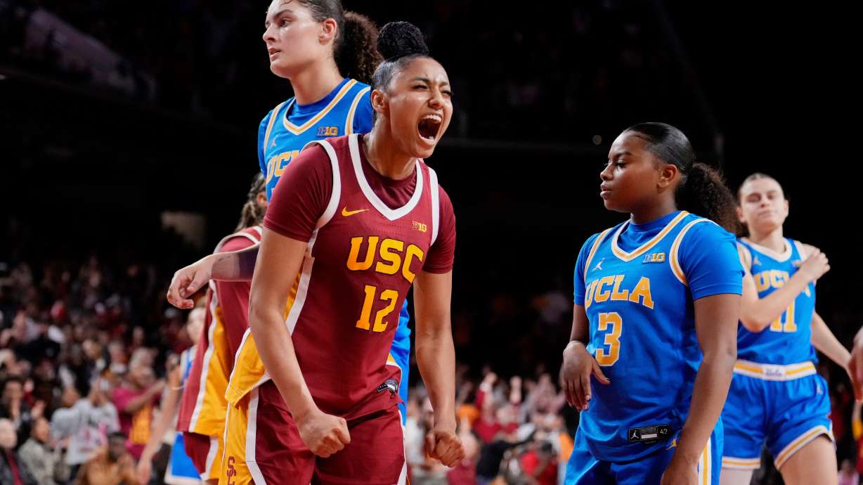 FILE - Southern California guard JuJu Watkins (12) celebrates after scoring as UCLA center Lauren Betts (51) and guard Londynn Jones (3) look on during the second half of an NCAA college basketball game, Thursday, Feb. 13, 2025, in Los Angeles.