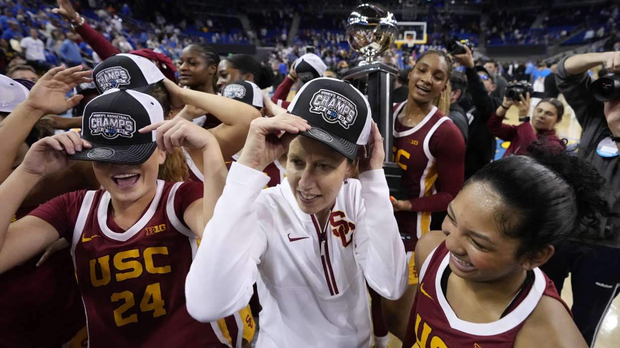 Southern California head coach Lindsay Gottlieb, center, celebrates with her team after they defeated UCLA in an NCAA college basketball game Saturday, March 1, 2025, in Los Angeles.