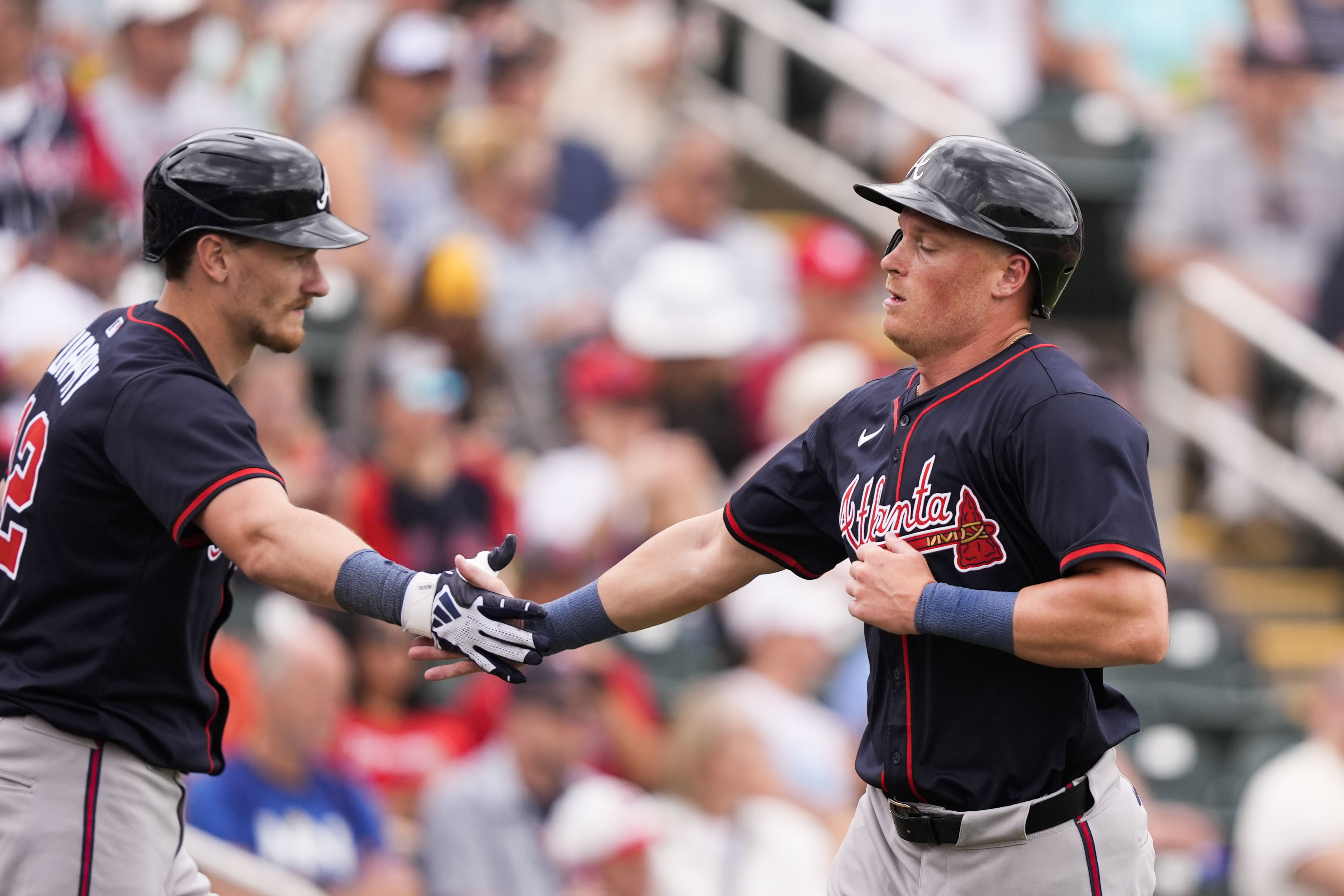 Atlanta Braves Conner Capel is greeted by Sean Murphy, left, after scoring on an RBI single by Nick Allen in the third inning of a spring training baseball game against the Minnesota Twins in Fort Myers, Fla., Saturday, Feb. 22, 2025.