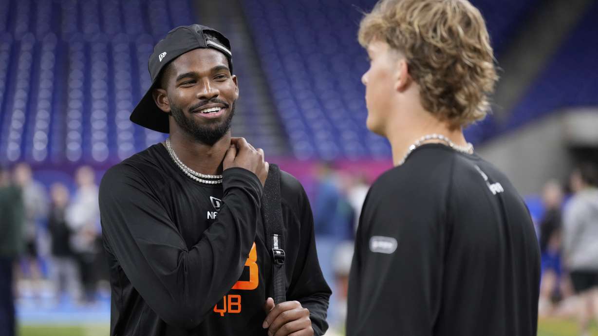 Colorado quarterback Shedeur Sanders talks to Mississippi quarterback Jaxson Dart at the NFL football scouting combine in Indianapolis, Saturday, March 1, 2025.