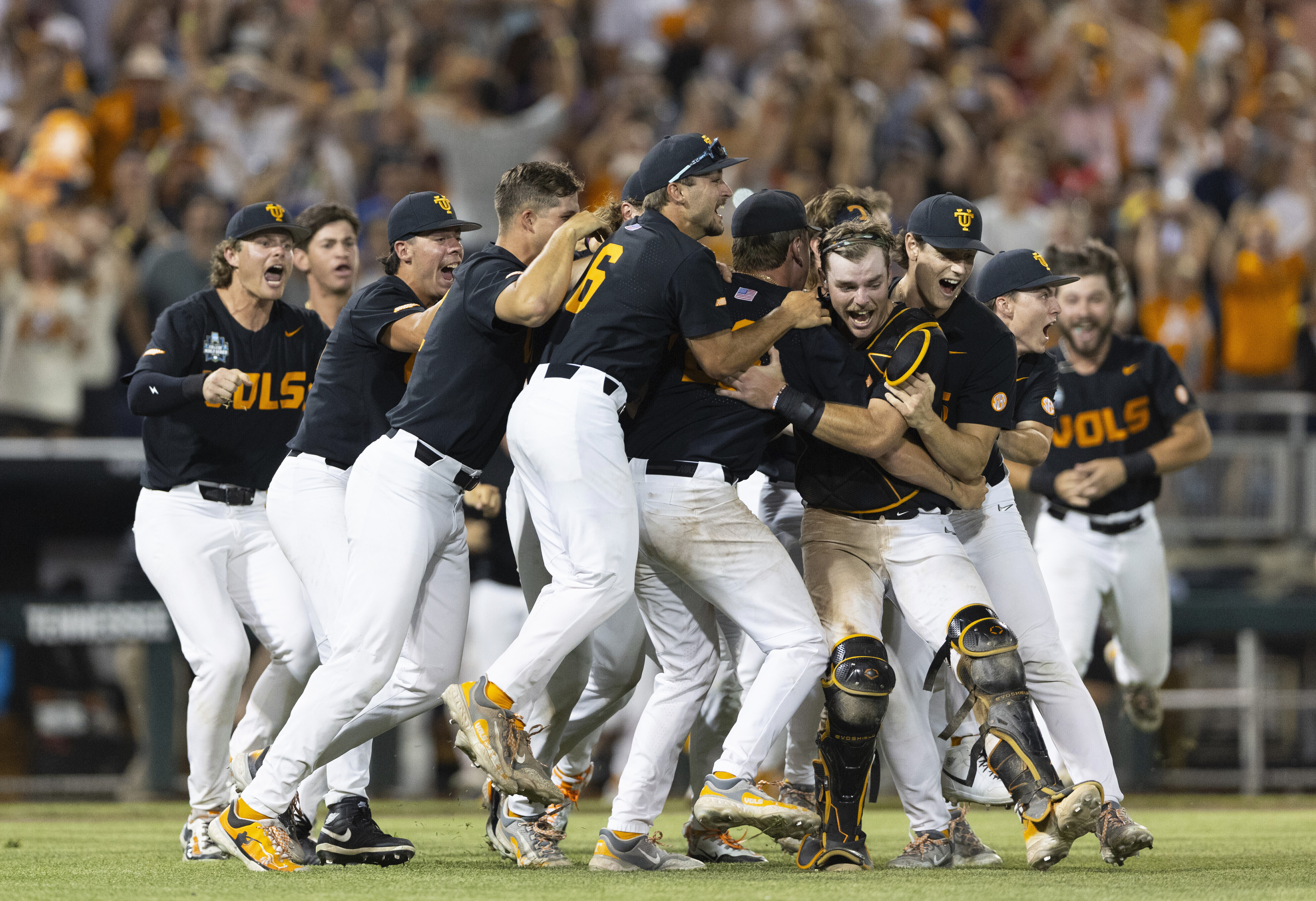 FILE - Tennessee players celebrate their 6-5 victory against Texas A&M in Game 3 of the NCAA College World Series baseball finals in Omaha, Neb., June 24, 2024. 