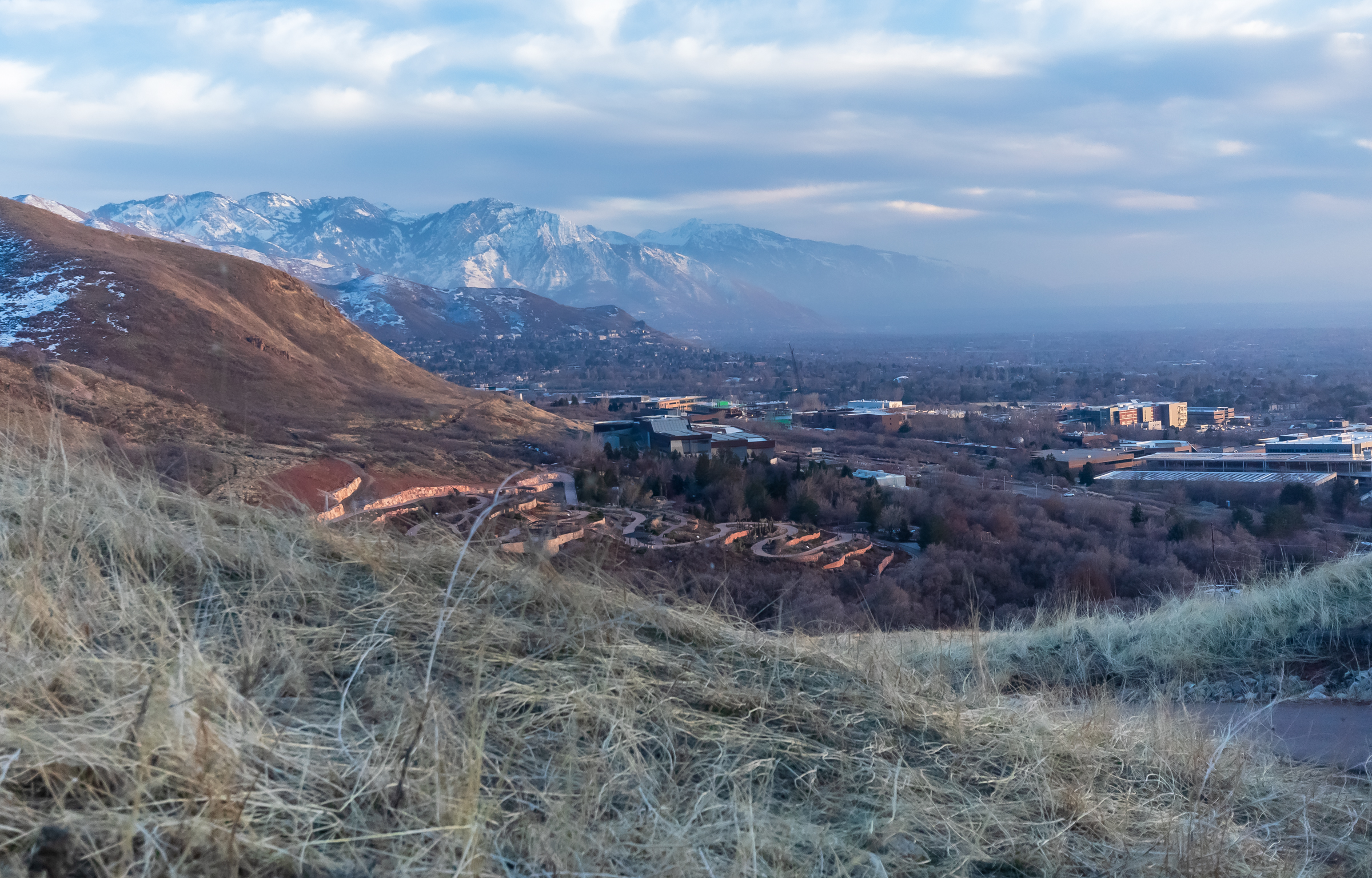 The snow-covered Wasatch Mountains rise above their less-snowy foothills at Red Butte Canyon in Salt Lake City on Saturday. The city's official snowfall remains on track to be the lowest on record despite above-normal precipitation throughout winter.