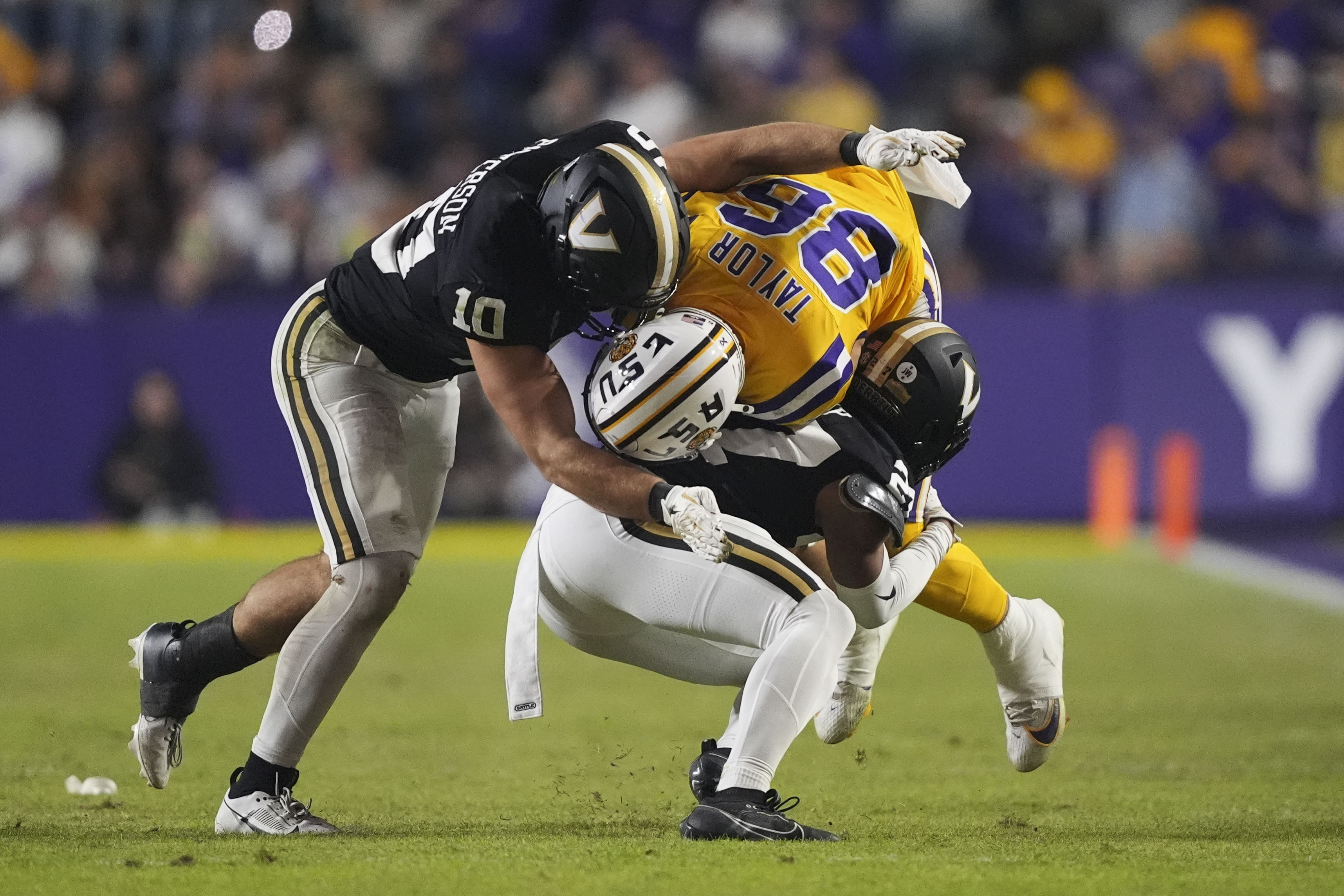 FILE - LSU tight end Mason Taylor (86) is tackled by Vanderbilt linebacker Langston Patterson (10) and cornerback Jaylin Lackey in the second half of an NCAA college football game in Baton Rouge, La., Saturday, Nov. 23, 2024. 