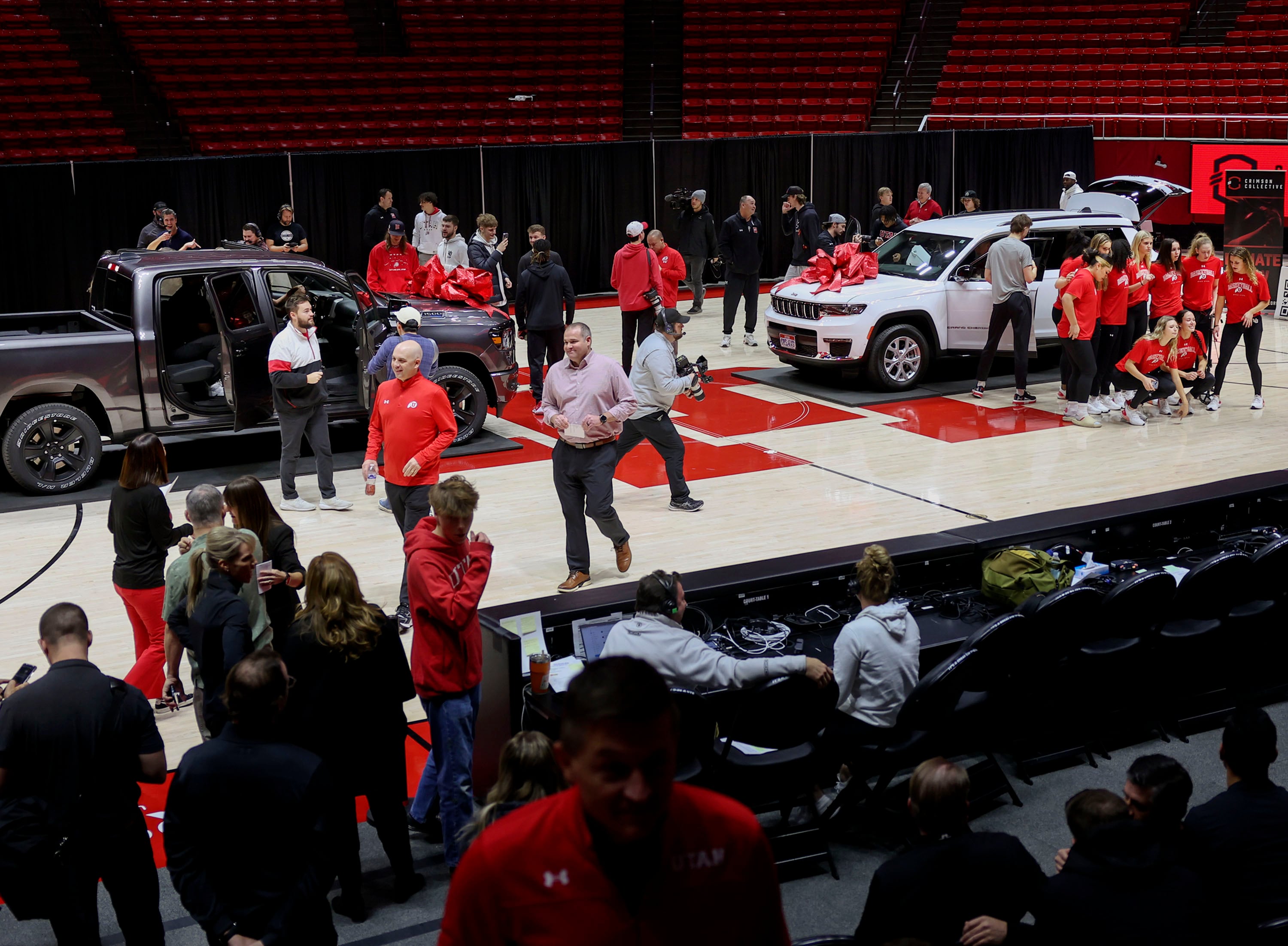 Members of the women’s gymnastics and men’s and women’s basketball programs look at vehicles at the Huntsman Center in Salt Lake City on Dec. 13, 2023. One state senator wondered if a bill allowing compensation for college athletes is just a "clever" way to pay them for playing sports.