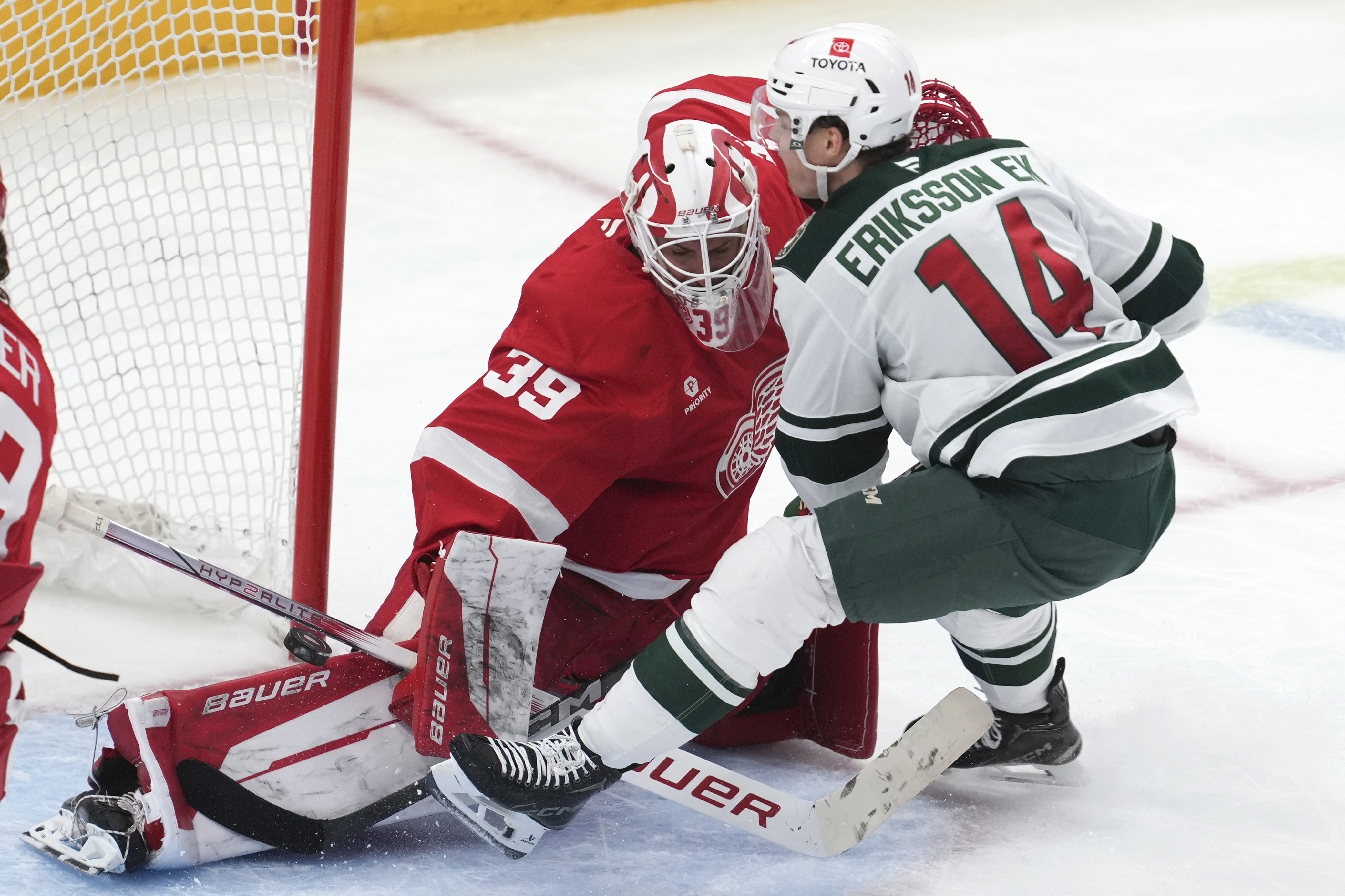 Detroit Red Wings goaltender Cam Talbot (39) stops a Minnesota Wild center Joel Eriksson Ek (14) shot in the third period of an NHL hockey game Saturday, Feb. 22, 2025, in Detroit. 
