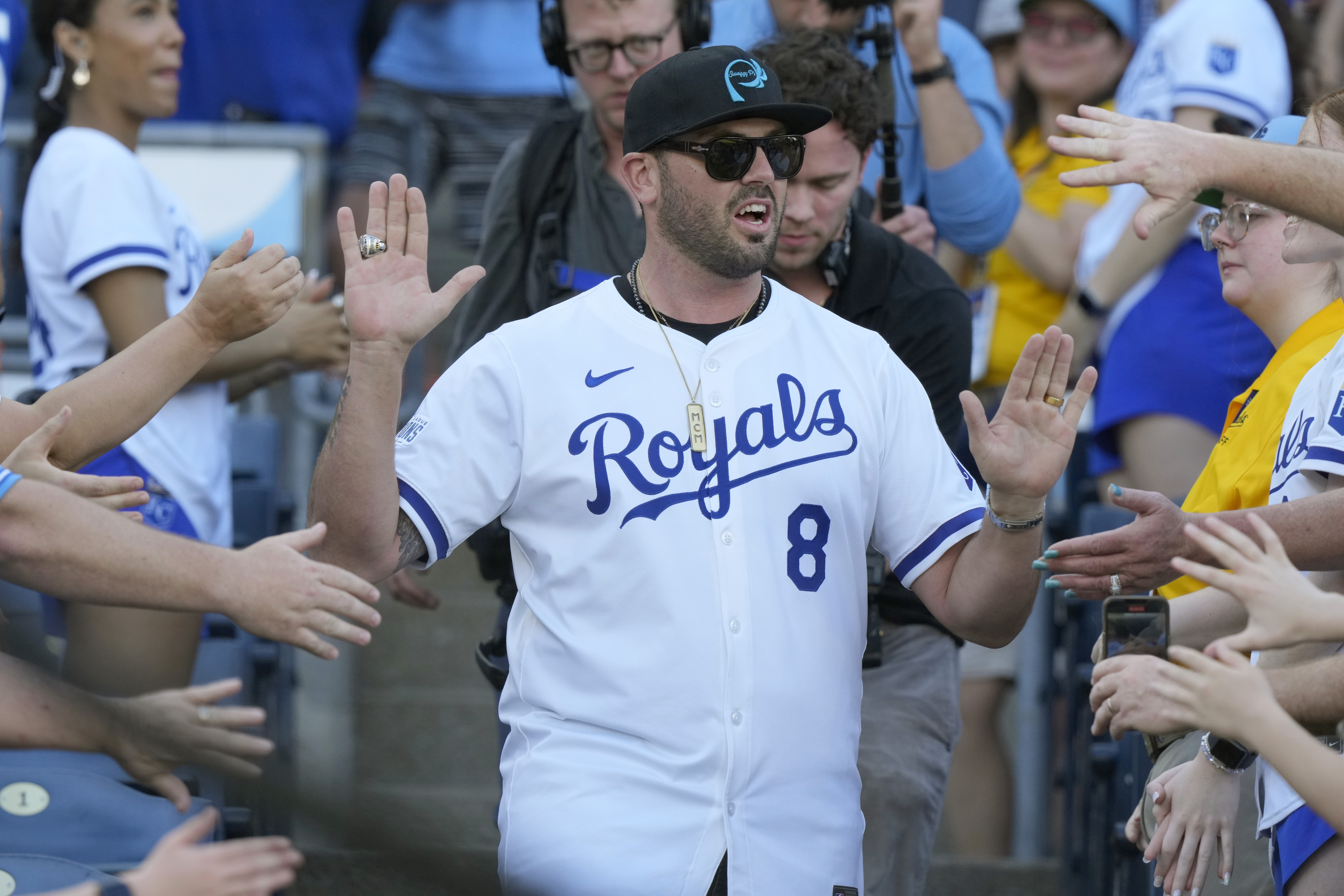 FILE - Former Kansas City Royals player Mike Moustakas greets fans during a celebration of the Royals' 2014 American League Championship before a baseball game against the Oakland Athletics, May 17, 2024, in Kansas City, Mo.