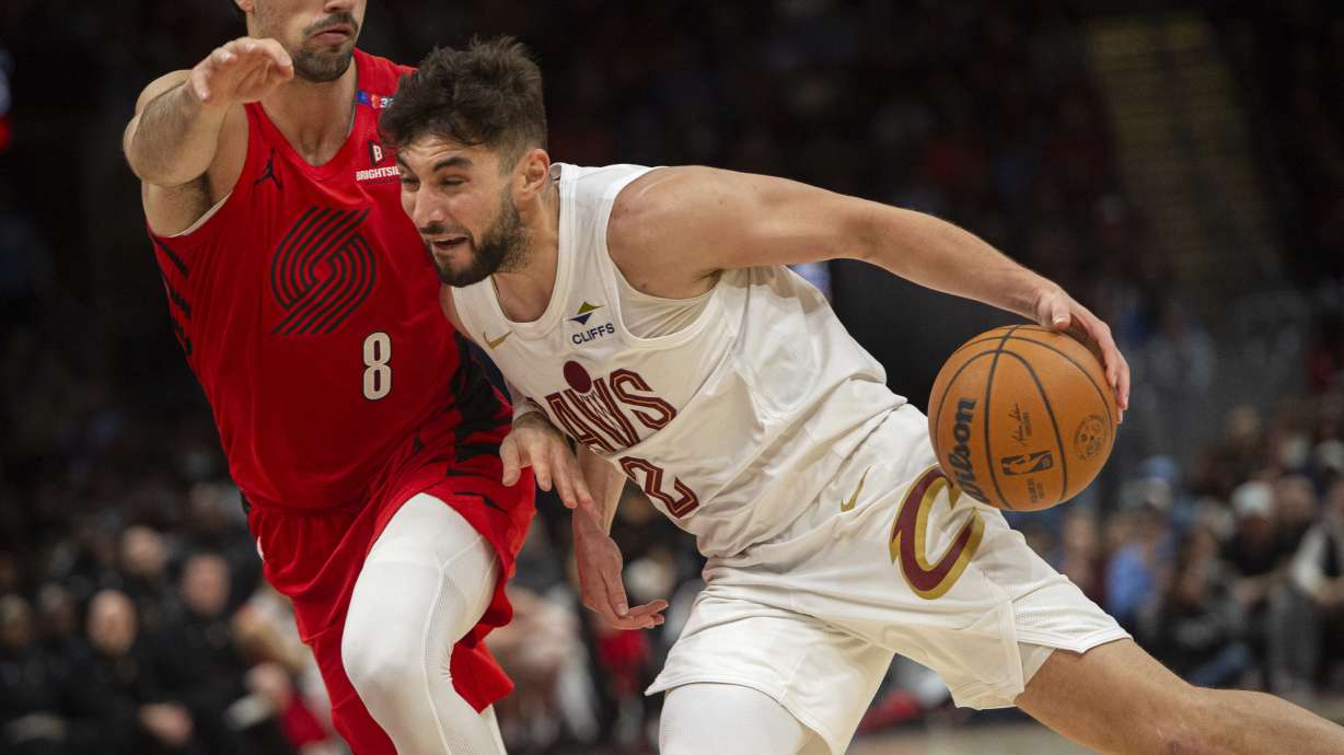Cleveland Cavaliers' Ty Jerome (2) drives as Portland Trail Blazers' Deni Avdija (8) defends during the second half of an NBA basketball game in Cleveland, Sunday, March 2, 2025.