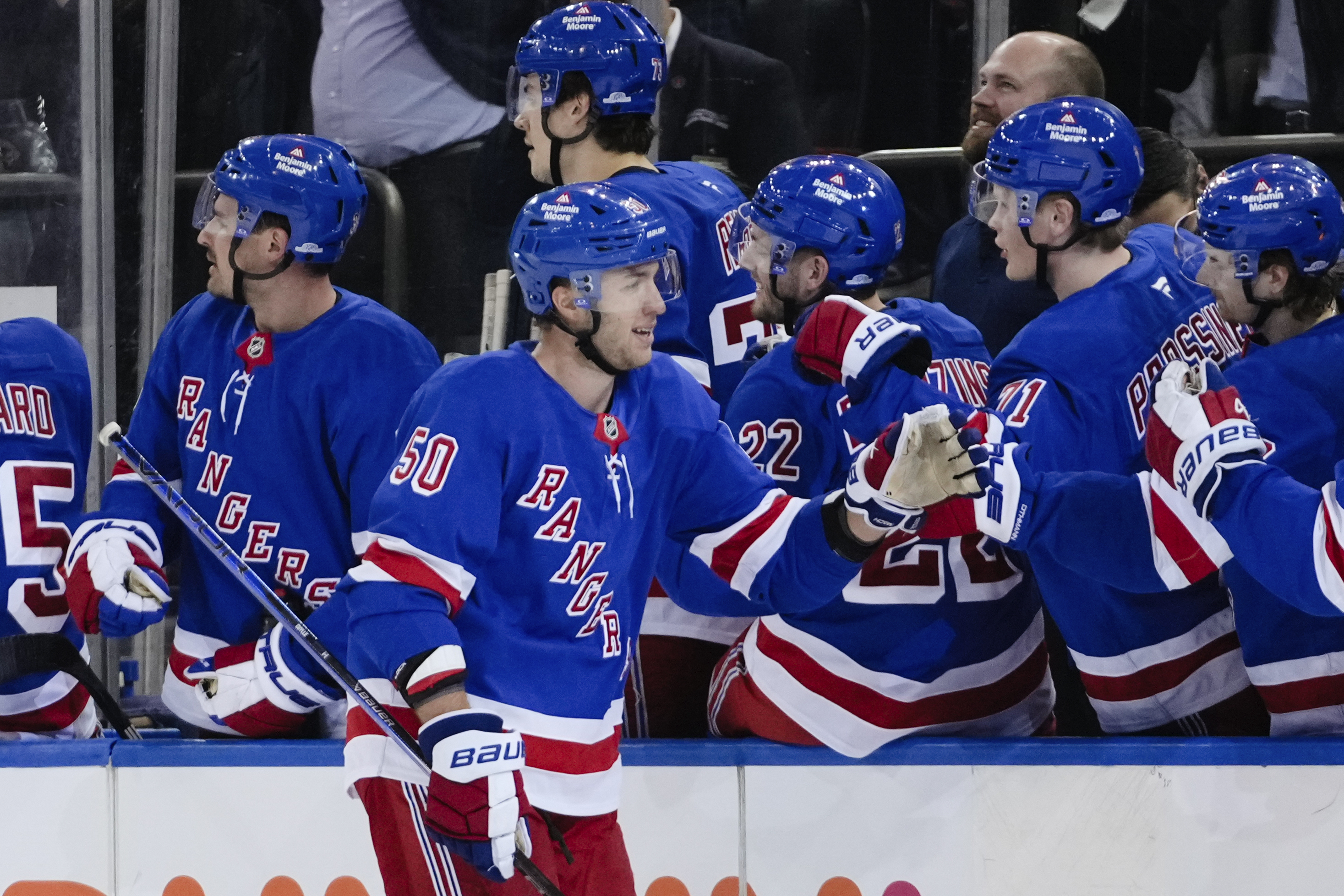 New York Rangers' Will Cuylle (50) celebrates with teammates after scoring a goal during the first period of an NHL hockey game against the New York Islanders Monday, March 3, 2025, in New York. 