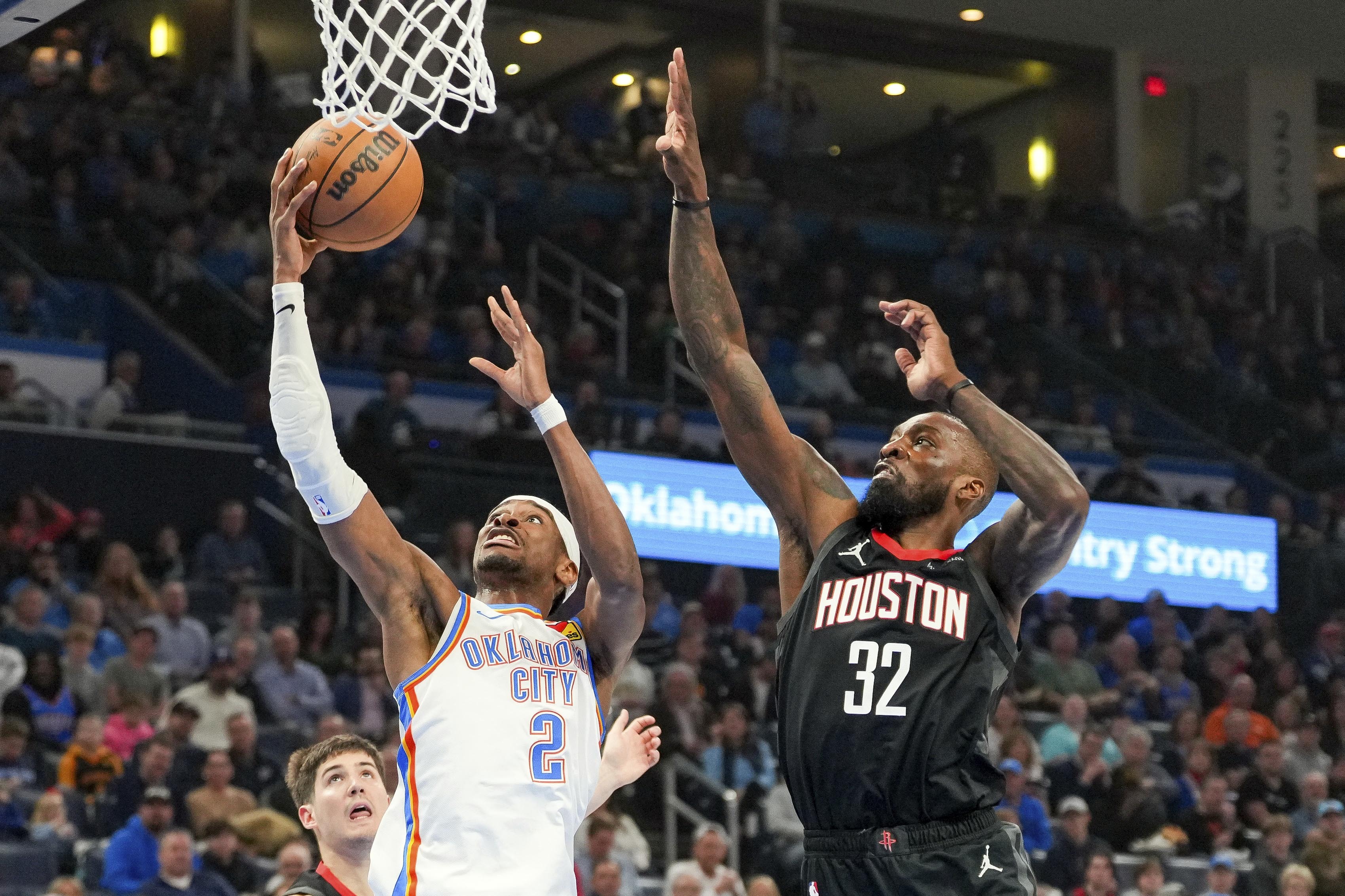 Oklahoma City Thunder guard Shai Gilgeous-Alexander (2) shoots over Houston Rockets forward Jeff Green (32) during the first half of an NBA basketball game, Monday, March 3, 2025, in Oklahoma City. 