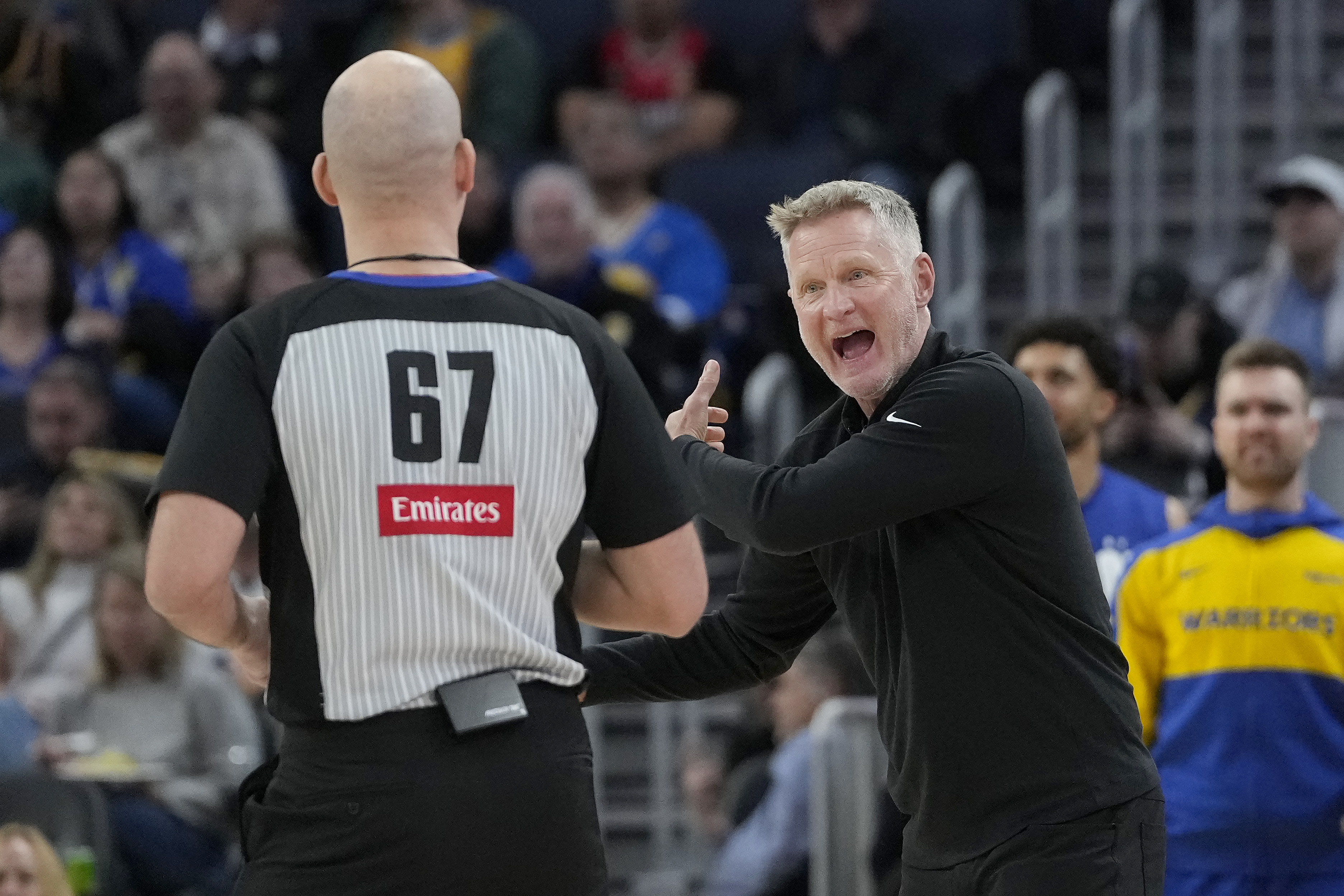 Golden State Warriors head coach Steve Kerr, right, reacts toward referee Brandon Adair (67) during the second half of an NBA basketball game between the Warriors and the Charlotte Hornets in San Francisco, Tuesday, Feb. 25, 2025. 