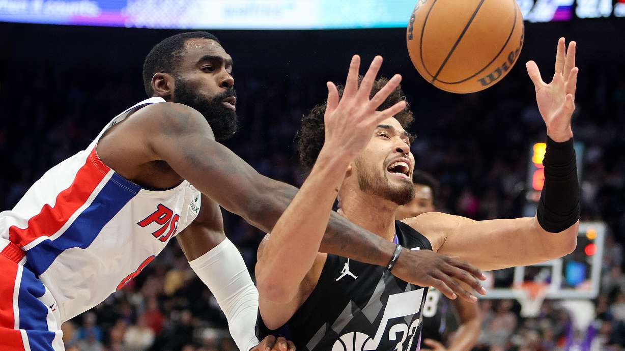Detroit Pistons forward Tim Hardaway Jr. (8) and Utah Jazz guard Johnny Juzang (33) reach for the ball during an NBA game at the Delta Center in Salt Lake City on Monday, March 3, 2025.