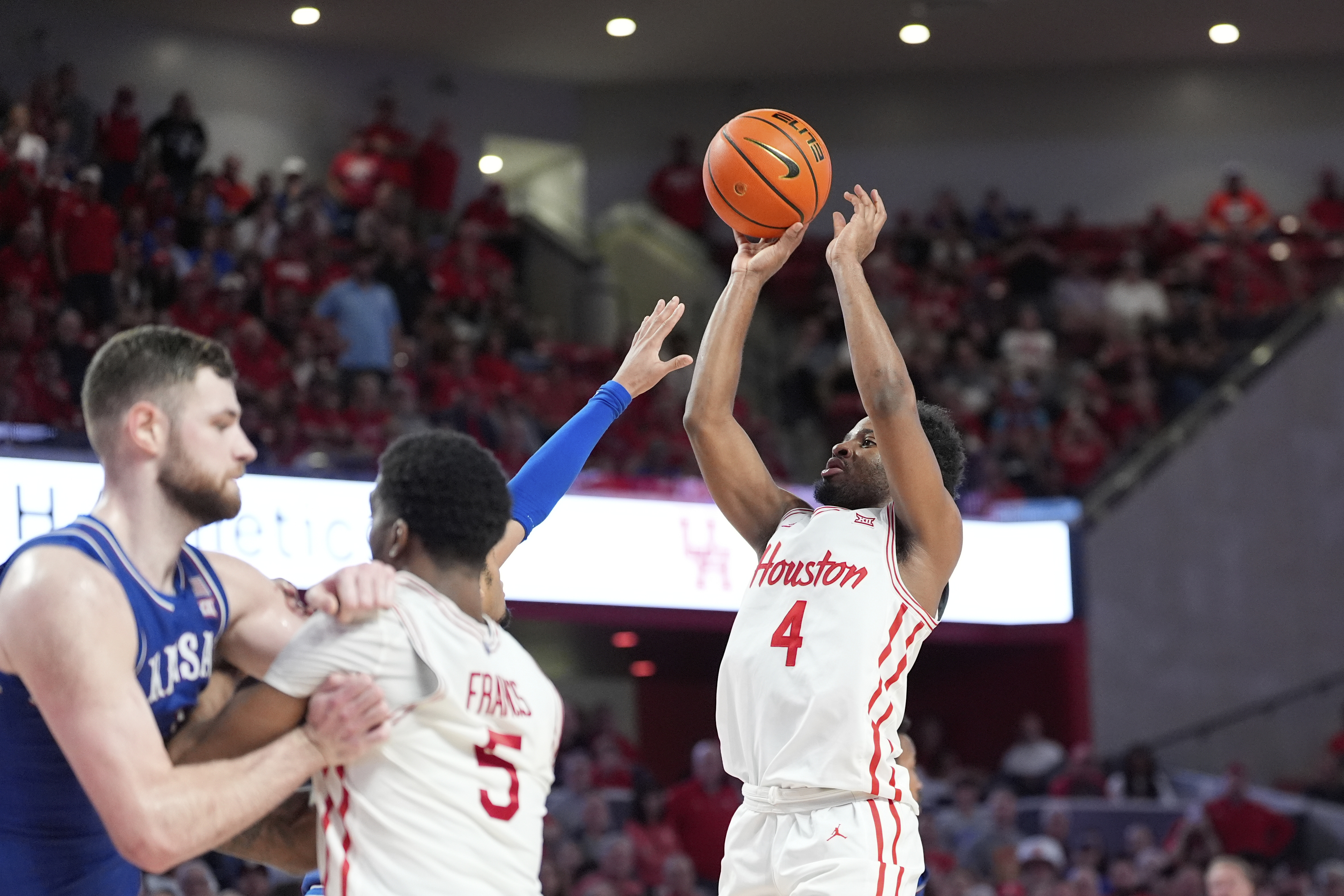 Houston's L.J. Cryer (4) shoots against Kansas during the second half of an NCAA college basketball game Monday, March 3, 2025, in Houston.