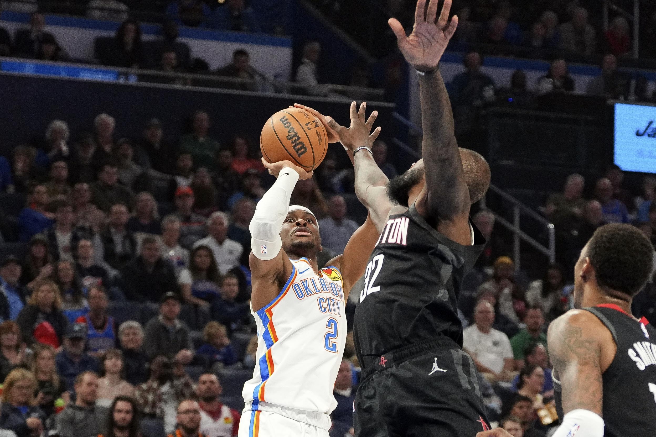 Oklahoma City Thunder guard Shai Gilgeous-Alexander, left, shoots over Houston Rockets forward Jeff Green, right, during the first half of an NBA basketball game, Monday, March 3, 2025, in Oklahoma City. 