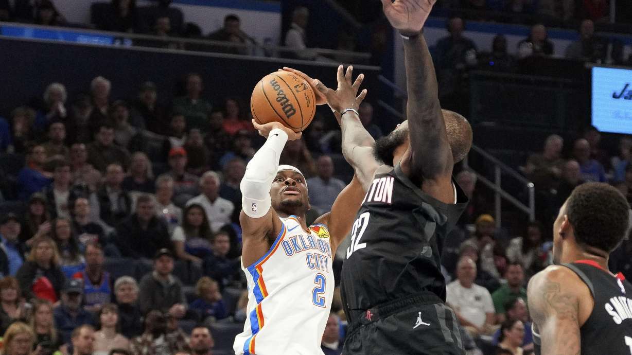 Oklahoma City Thunder guard Shai Gilgeous-Alexander, left, shoots over Houston Rockets forward Jeff Green, right, during the first half of an NBA basketball game, Monday, March 3, 2025, in Oklahoma City.