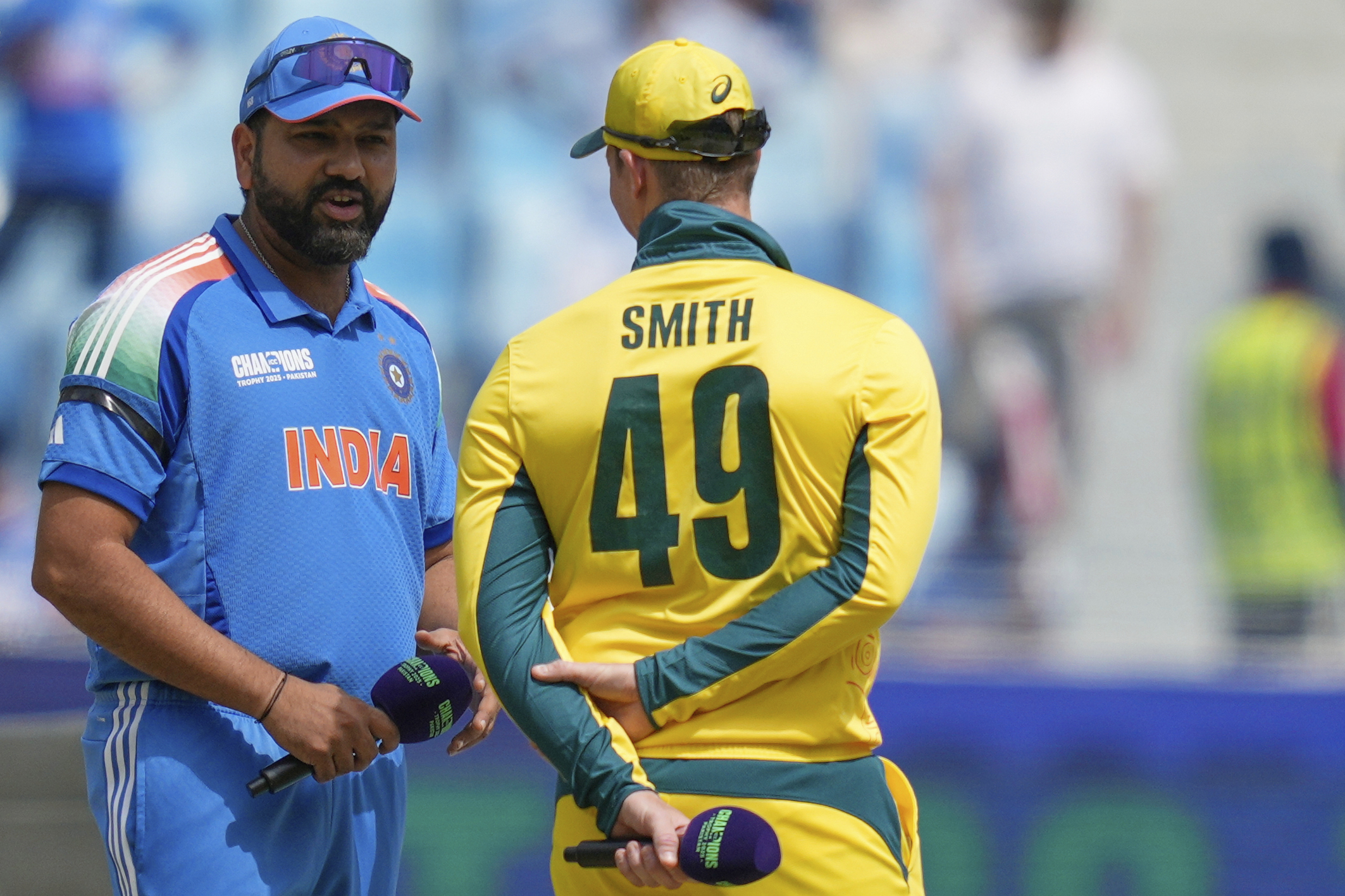 India's captain Rohit Sharma, left, speaks to Australia's captain Steve Smith at the toss ahead of the ICC Champions Trophy semifinal cricket match between India and Australia at Dubai International Cricket Stadium in Dubai, United Arab Emirates, Tuesday, March 4, 2025. 