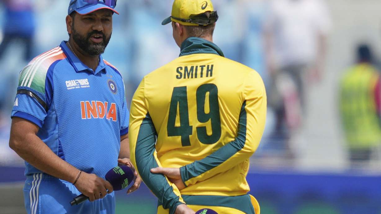 India's captain Rohit Sharma, left, speaks to Australia's captain Steve Smith at the toss ahead of the ICC Champions Trophy semifinal cricket match between India and Australia at Dubai International Cricket Stadium in Dubai, United Arab Emirates, Tuesday, March 4, 2025.