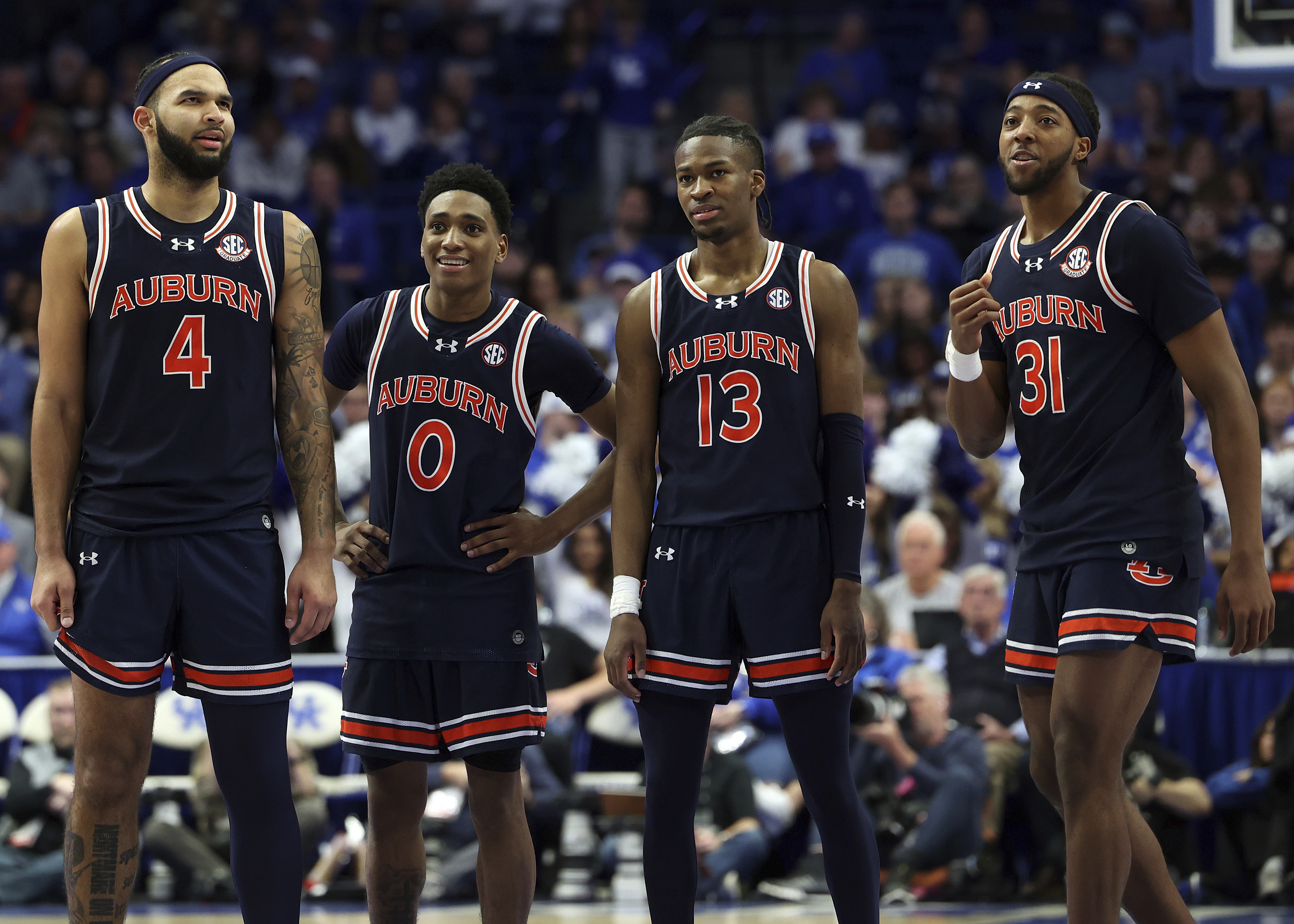 Auburn's Johni Broome (4), Tahaad Pettiford (0), Miles Kelly (13) and Chaney Johnson (31) pause in the closing moments of the second half of an NCAA college basketball game against Kentucky in Lexington, Ky., Saturday, March 1, 2025. 