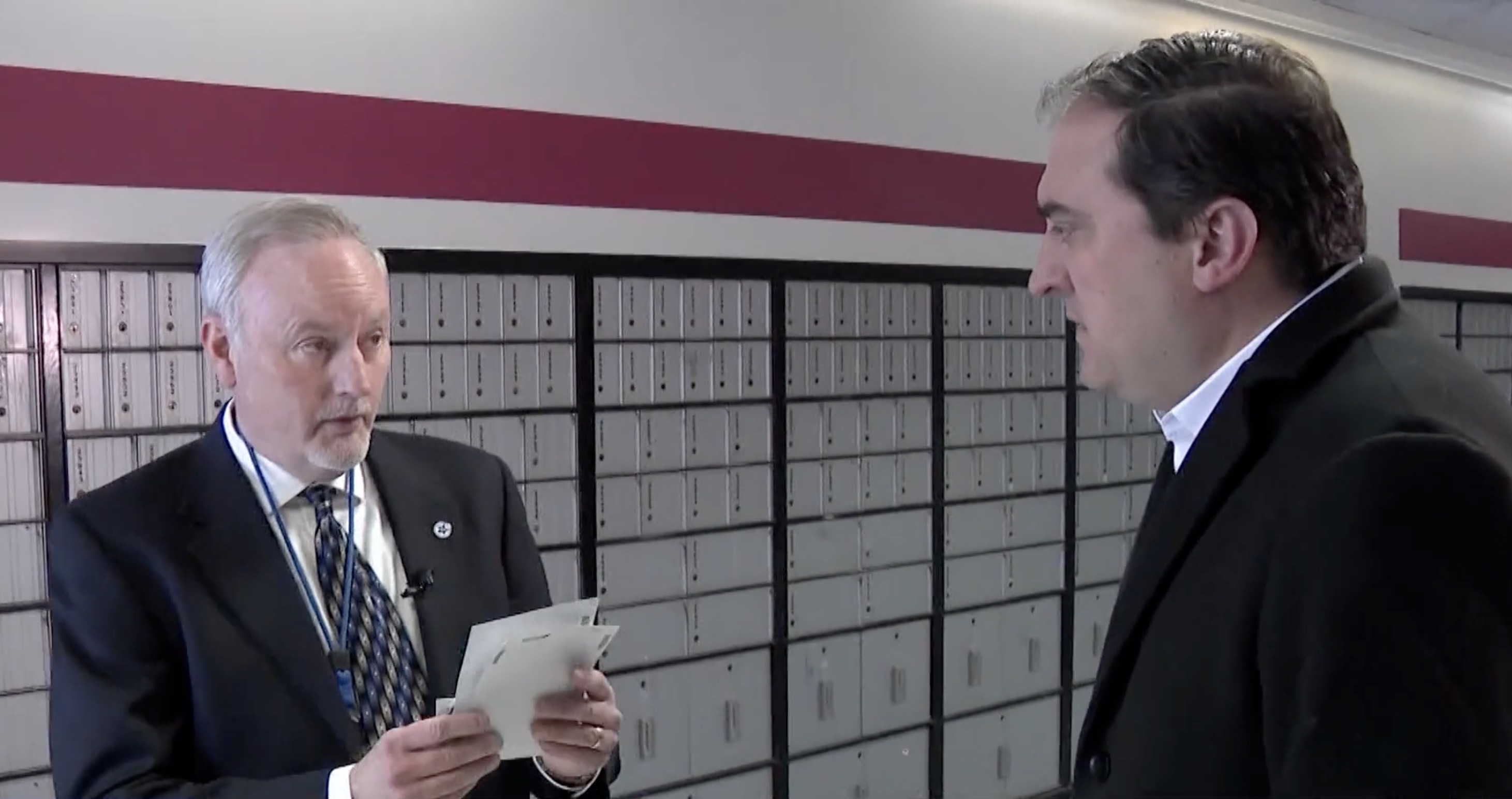 Brook Robinson, a U.S. postal inspector, left, tells Matt Gephardt that he could not tell if the stamps were real or fake by simply looking at them.
