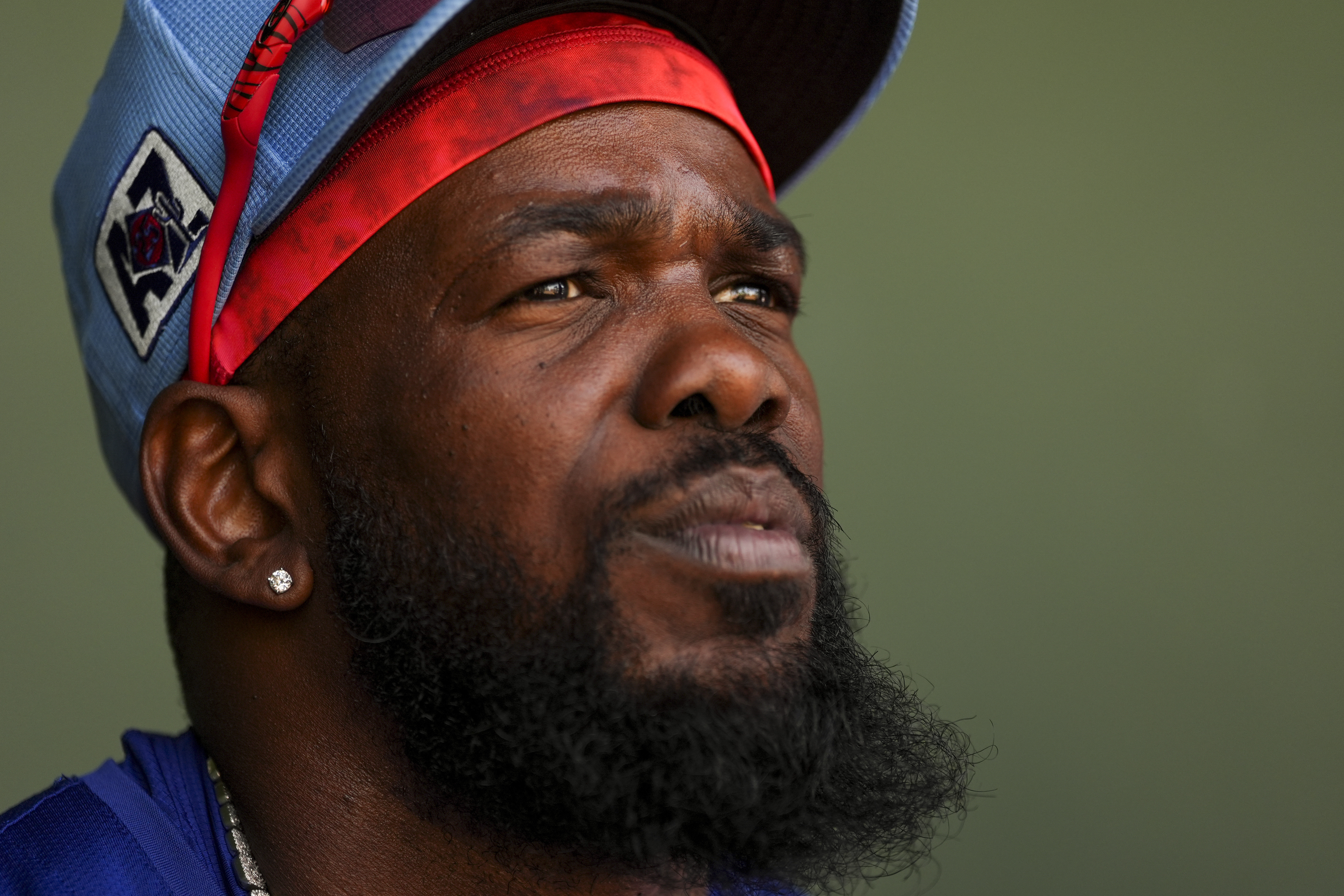 Texas Rangers right fielder Adolis García sits in the dugout before a spring training baseball game against the Chicago Cubs, Friday, Feb. 28, 2025, in Surprise, Ariz. 